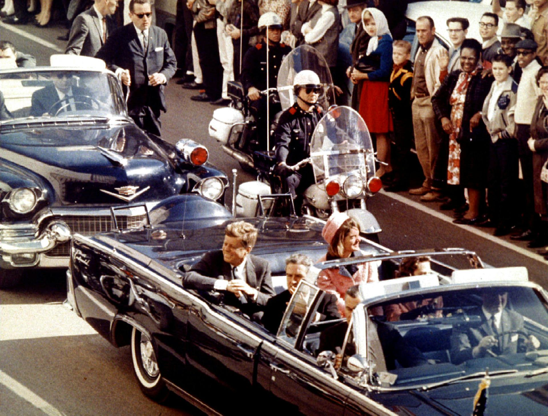 Jackie og John F. Kennedy i Dallas, Texas den 22. november 1963. Billedet er taget blot øjeblikke før det dræbende skud ramte.

