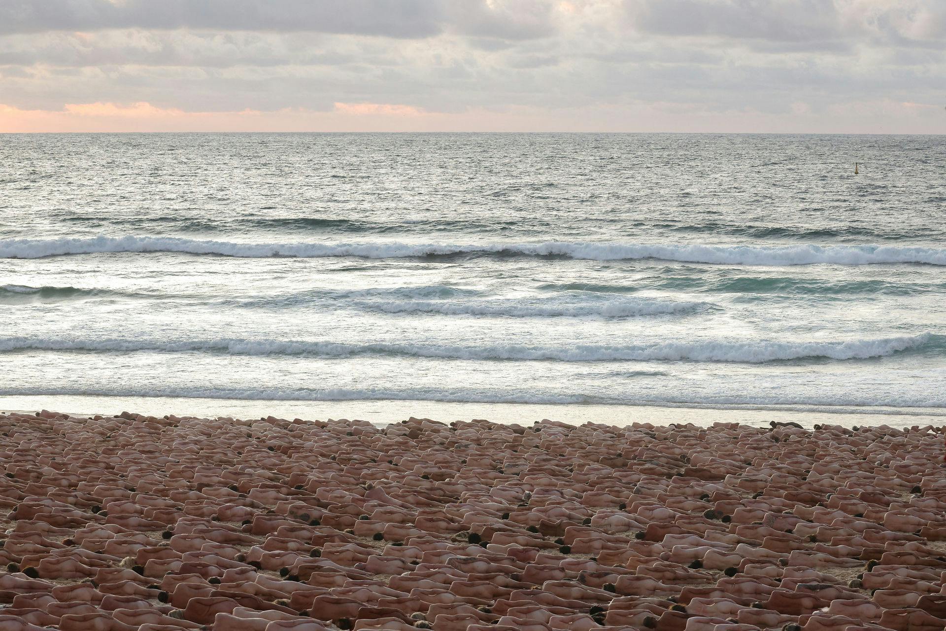 People stand naked as part of artist Spencer Tunick's art installation to raise awareness of skin cancer and encourage people to have their skin checked, at Bondi Beach in Sydney, Australia, November 26, 2022. REUTERS/Loren Elliott EDITORIAL USE ONLY