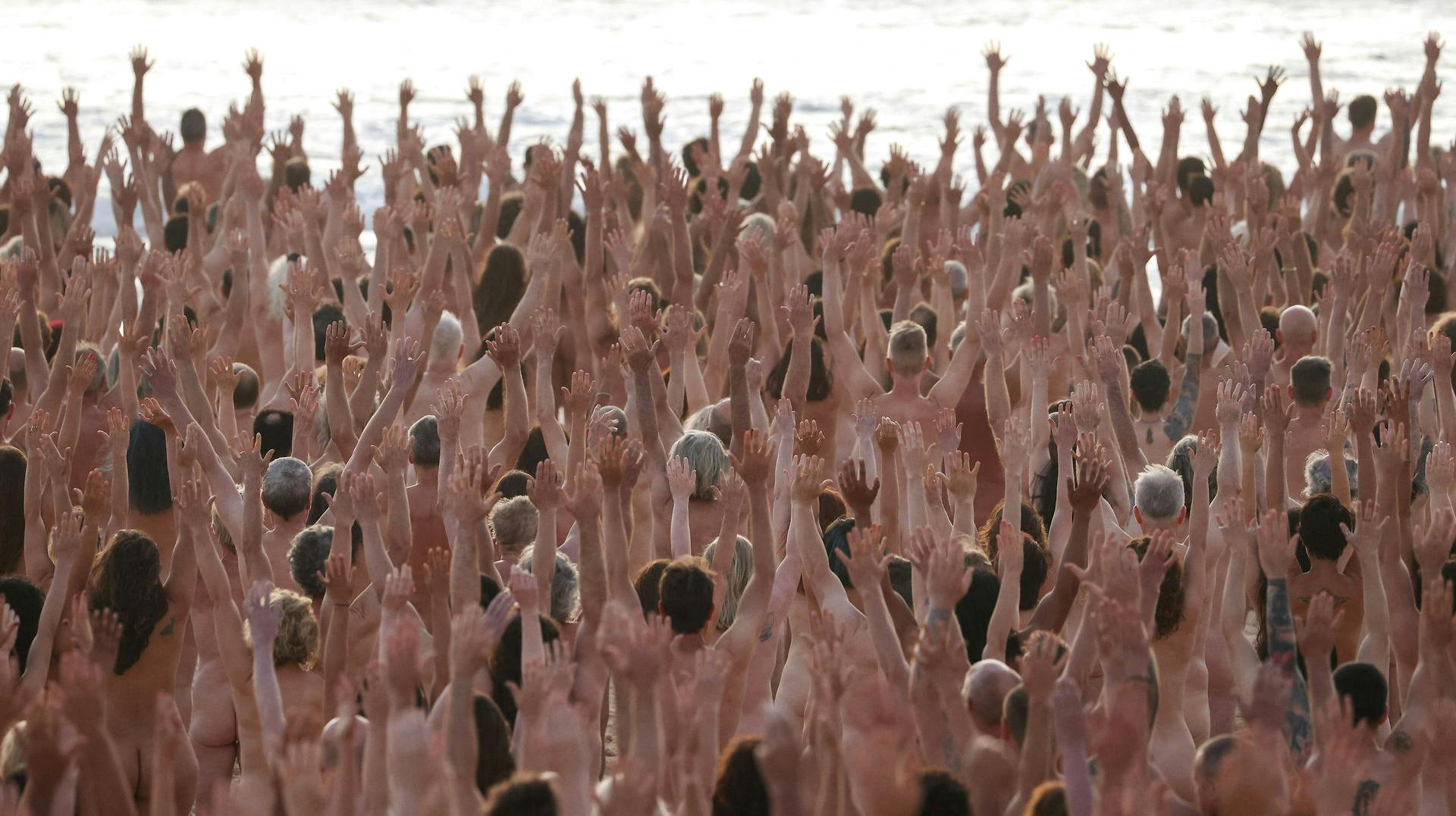 People stand naked as part of artist Spencer Tunick's art installation to raise awareness of skin cancer and encourage people to have their skin checked, at Bondi Beach in Sydney, Australia, November 26, 2022. REUTERS/Loren Elliott EDITORIAL USE ONLY.