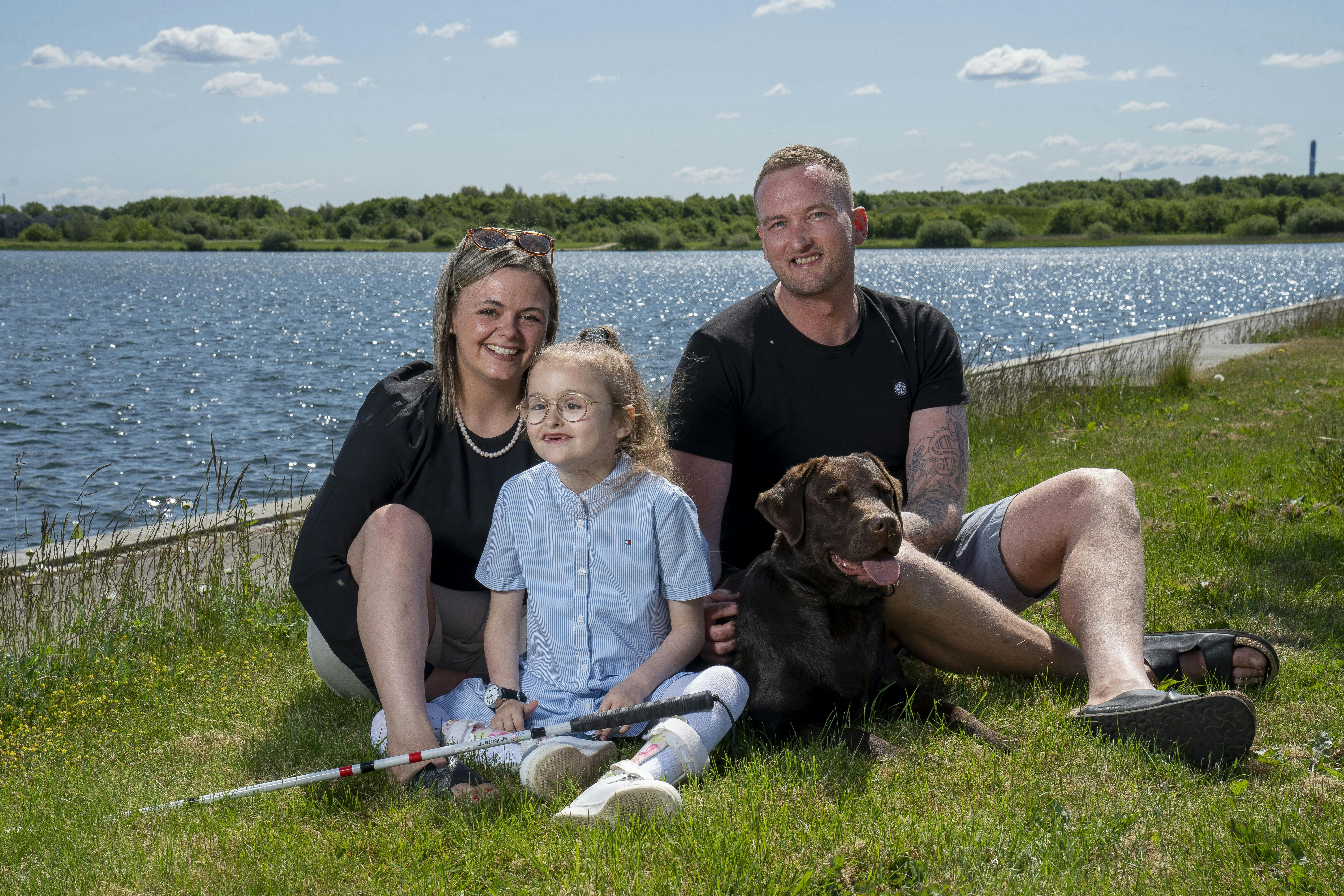 Isabella med sine forældre, Rikke og Thomas, samt familiens hund, Sigurd.
