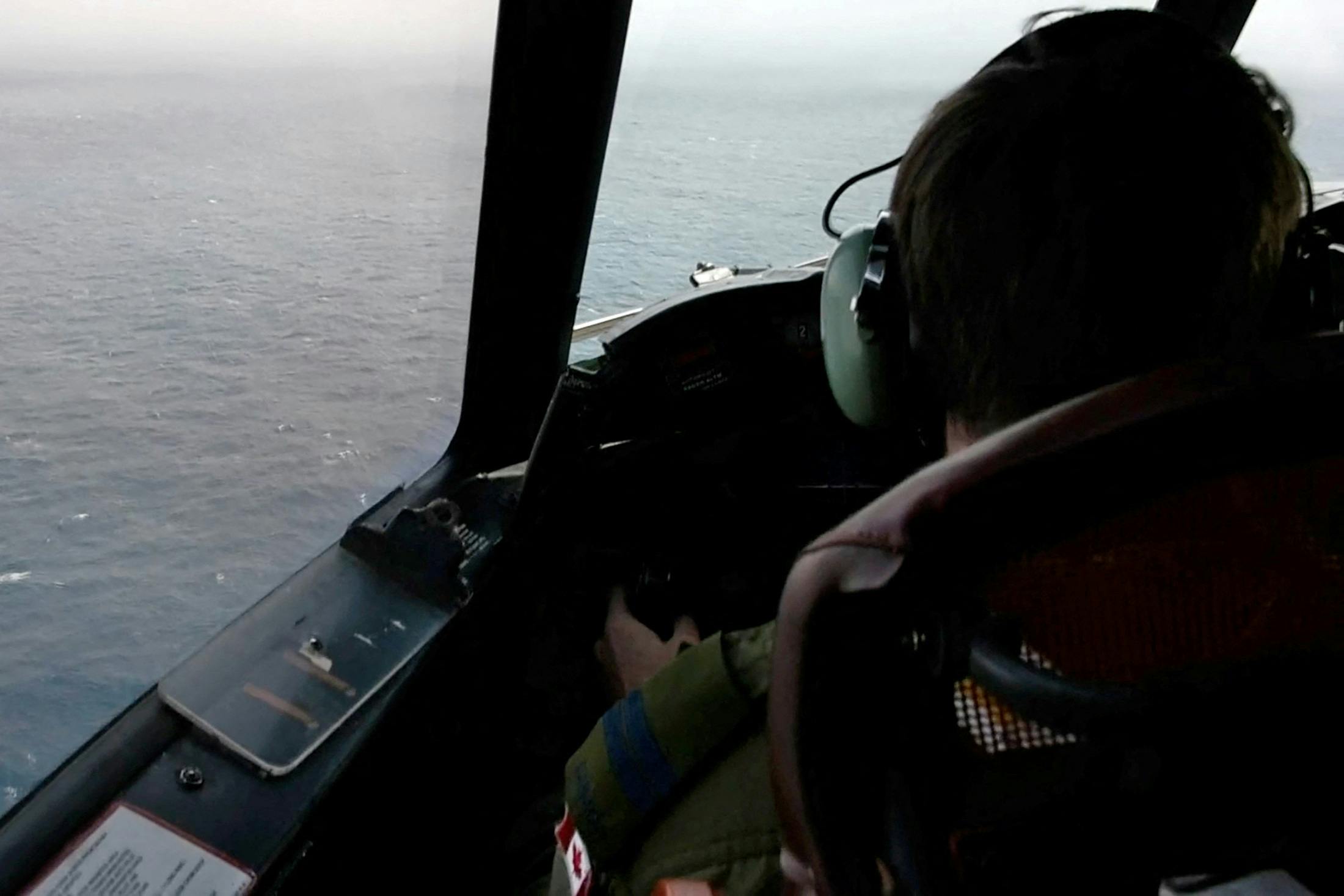 The pilot of a Royal Canadian Air Force CP-140 Aurora maritime surveillance aircraft of 14 Wing flies a search pattern for the missing OceanGate submersible, which had been carrying five people to explore the wreck of the sunken SS Titanic, in the Atlantic Ocean off Newfoundland, Canada June 20, 2023 in a still image from video. Canadian Forces/Handout via REUTERS THIS IMAGE HAS BEEN SUPPLIED BY A THIRD PARTY.
