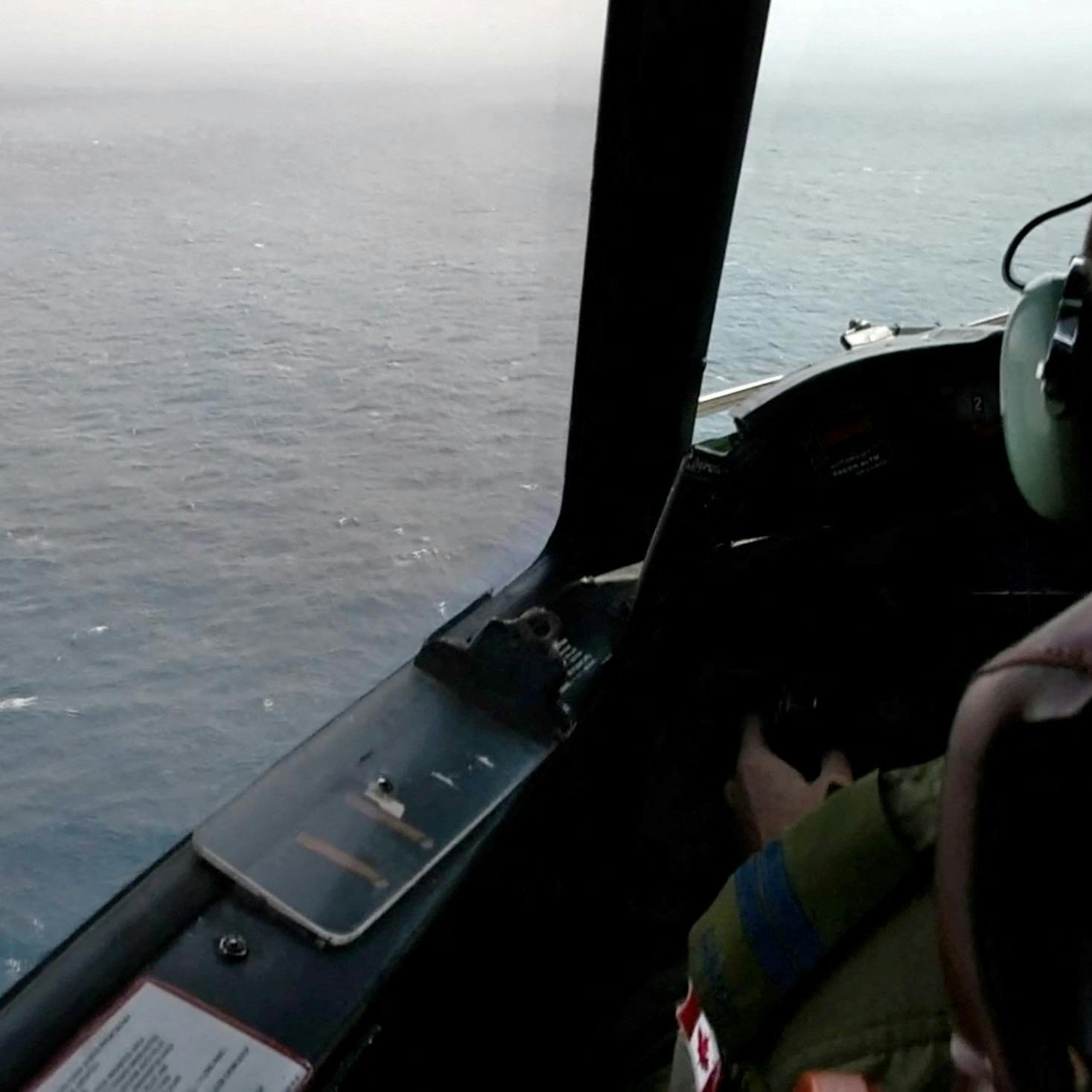 The pilot of a Royal Canadian Air Force CP-140 Aurora maritime surveillance aircraft of 14 Wing flies a search pattern for the missing OceanGate submersible, which had been carrying five people to explore the wreck of the sunken SS Titanic, in the Atlantic Ocean off Newfoundland, Canada June 20, 2023 in a still image from video. Canadian Forces/Handout via REUTERS THIS IMAGE HAS BEEN SUPPLIED BY A THIRD PARTY.