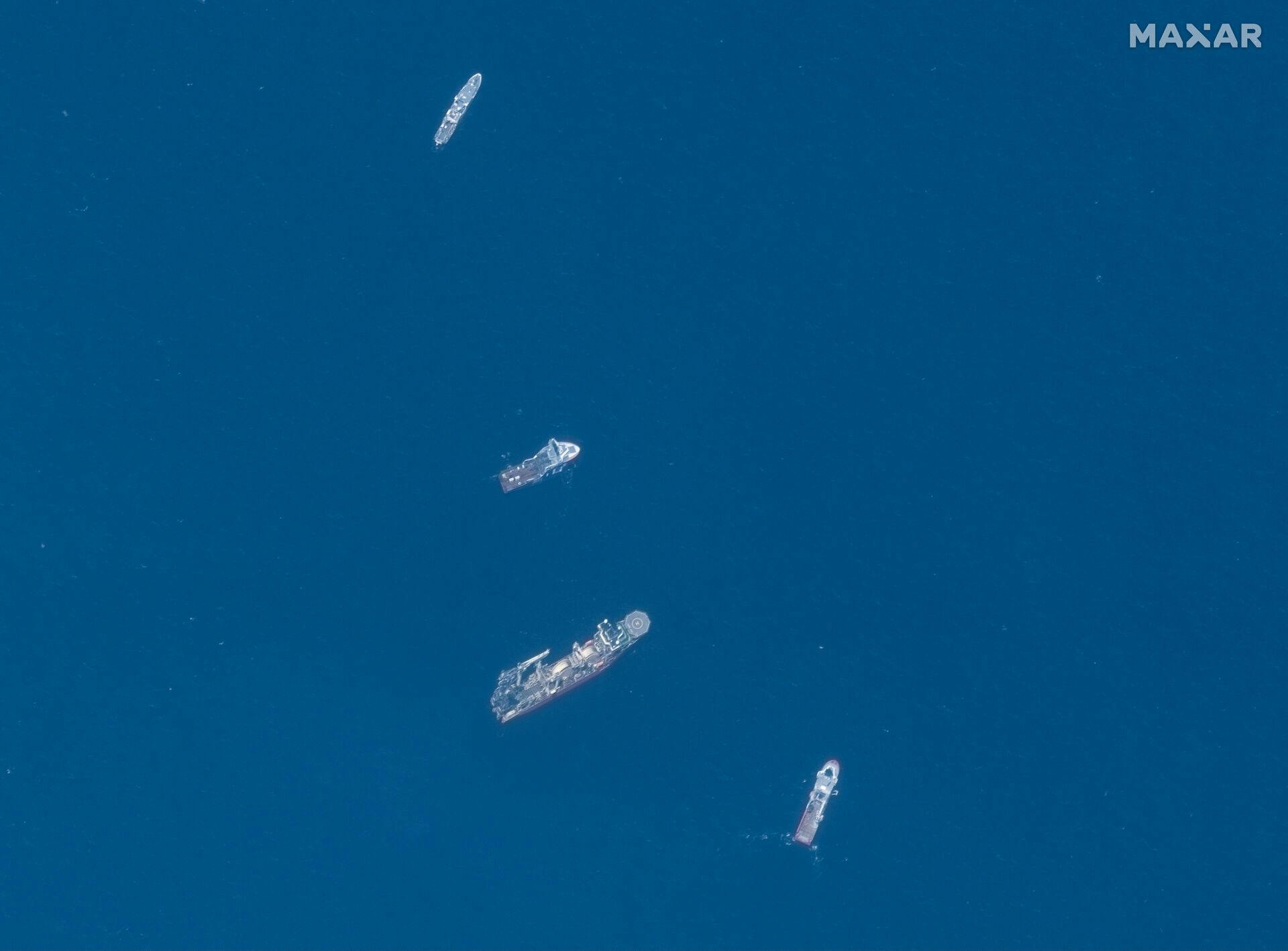 A satellite image shows ships taking part in the search and rescue operations associated with the missing Titan submersible near the wreck of the Titanic, June 22, 2023. Maxar Technologies/Handout via REUTERS THIS IMAGE HAS BEEN SUPPLIED BY A THIRD PARTY.NO RESALES.NO ARCHIVES. MANDATORY CREDIT. DO NOT OBSCURE LOGO. TPX IMAGES OF THE DAY