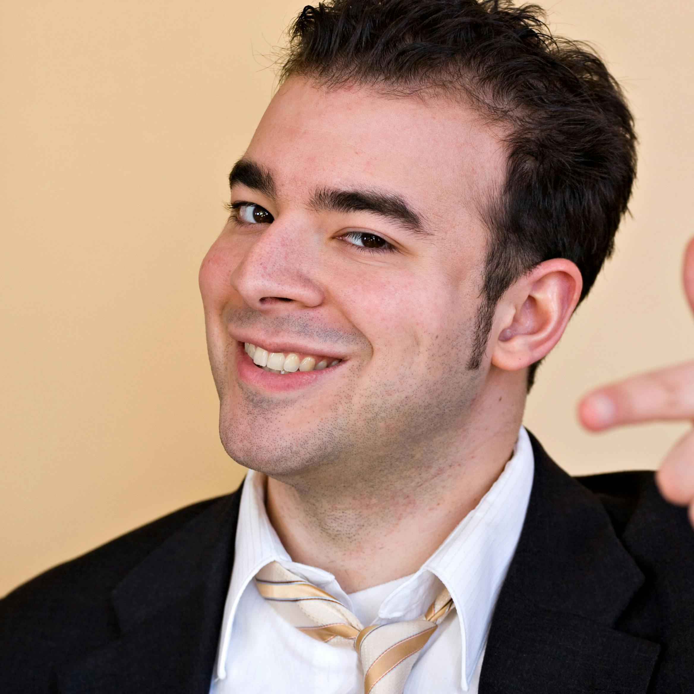 A goofy smiling business man pointing and trying to act like he is a cool guy. Shallow depth of field with focus on the face.
