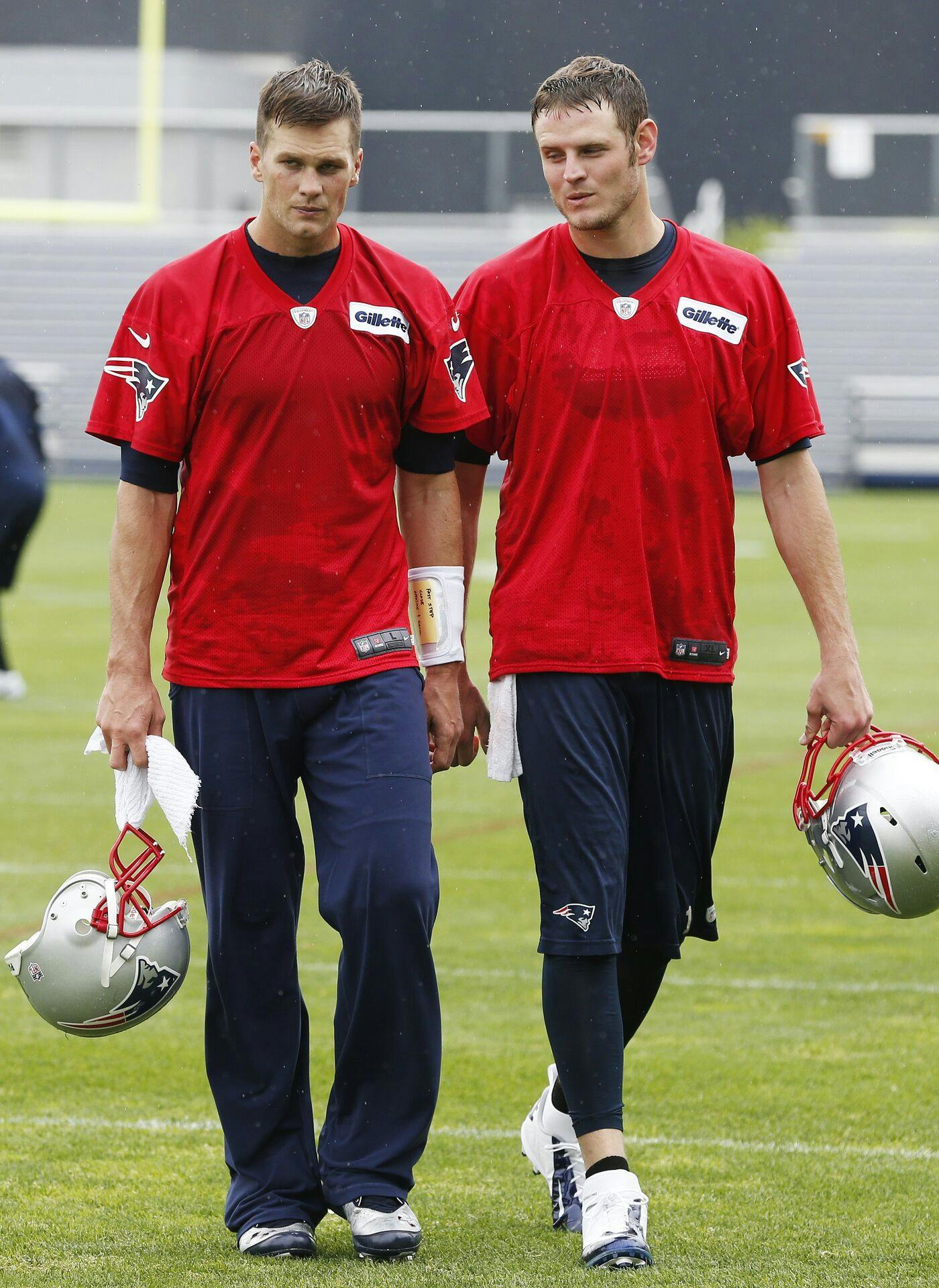 New England Patriots quarterbacks Tom Brady, left, and Ryan Mallet walk off the field after team football practice in Foxborough, Mass., Wednesday, May 29, 2013. (AP Photo/Michael Dwyer)