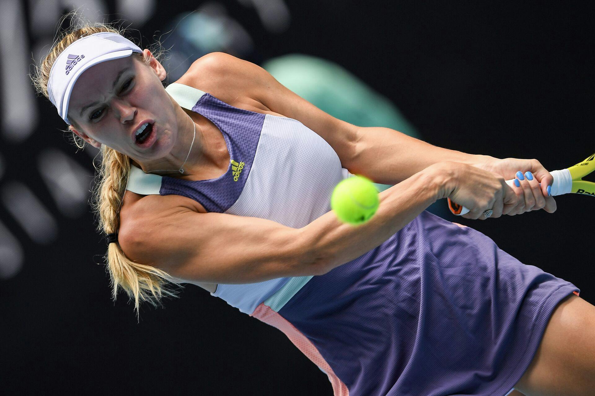 Denmark's Caroline Wozniacki hits a return against Tunisia's Ons Jabeur during their women's singles match on day five of the Australian Open tennis tournament in Melbourne on January 24, 2020. (Photo by Greg Wood / AFP) / IMAGE RESTRICTED TO EDITORIAL USE - STRICTLY NO COMMERCIAL USE