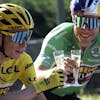 Denmark's Jonas Vingegaard, wearing the overall leader's yellow jersey, toasts champagne with teammates Belgium's Wout Van Aert, wearing the best sprinter's green jersey during the twenty-first stage of the Tour de France cycling race over 116 kilometers (72 miles) with start in Paris la Defense Arena and finish on the Champs Elysees in Paris, France, Sunday, July 24, 2022. (Thomas Samson/Pool Photo via AP)