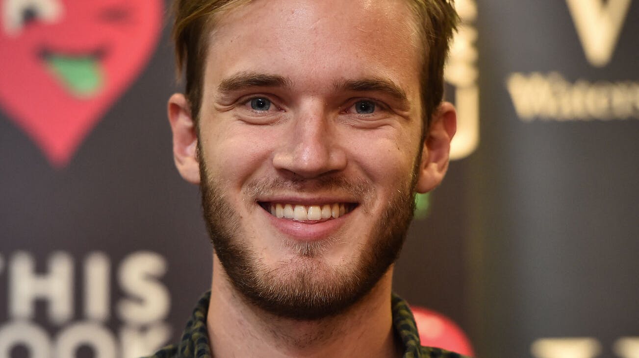 Swedish video game commentator Felix Kjellberg, aka PewDiePie poses with his new book, 'This book loves you' at an event in central London, on October 18, 2015. AFP PHOTO / BEN STANSALL. BEN STANSALL / AFP