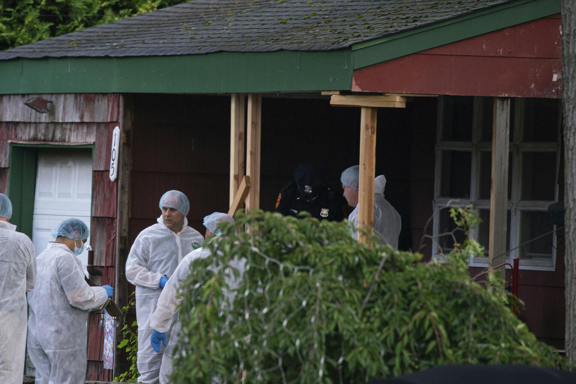 Crime laboratory officers arrive to the house where a suspect has been taken into custody on New York's Long Island in connection with a long-unsolved string of killings, known as the Gilgo Beach murders, Friday, July 14, 2023, in Massapequa, N.Y. (AP Photo/Eduardo Munoz Alvarez)
