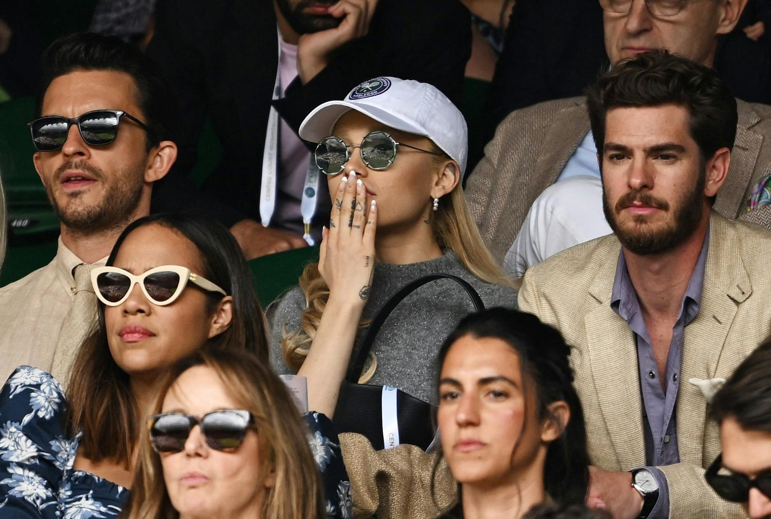 Tennis - Wimbledon - All England Lawn Tennis and Croquet Club, London, Britain - July 16, 2023 Actor Jonathan Bailey, singer Ariana Grande and actor Andrew Garfield in the stands during the men's singles final REUTERS/Dylan Martinez