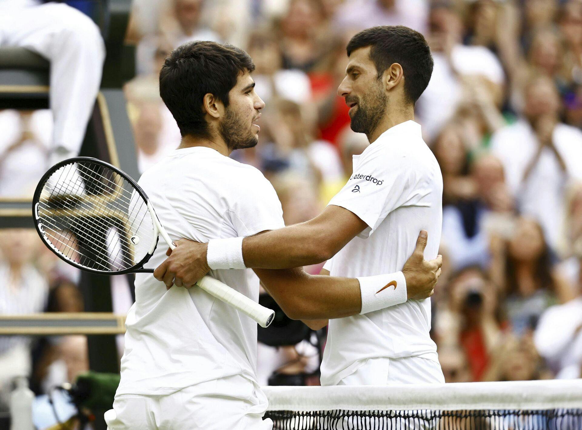 Spain's Carlos Alcaraz (L) hugs Serbia's Novak Djokovic after beating him in the men's singles final at the Wimbledon tennis tournament in London on July 16, 2023. (Kyodo via AP Images) ==Kyodo