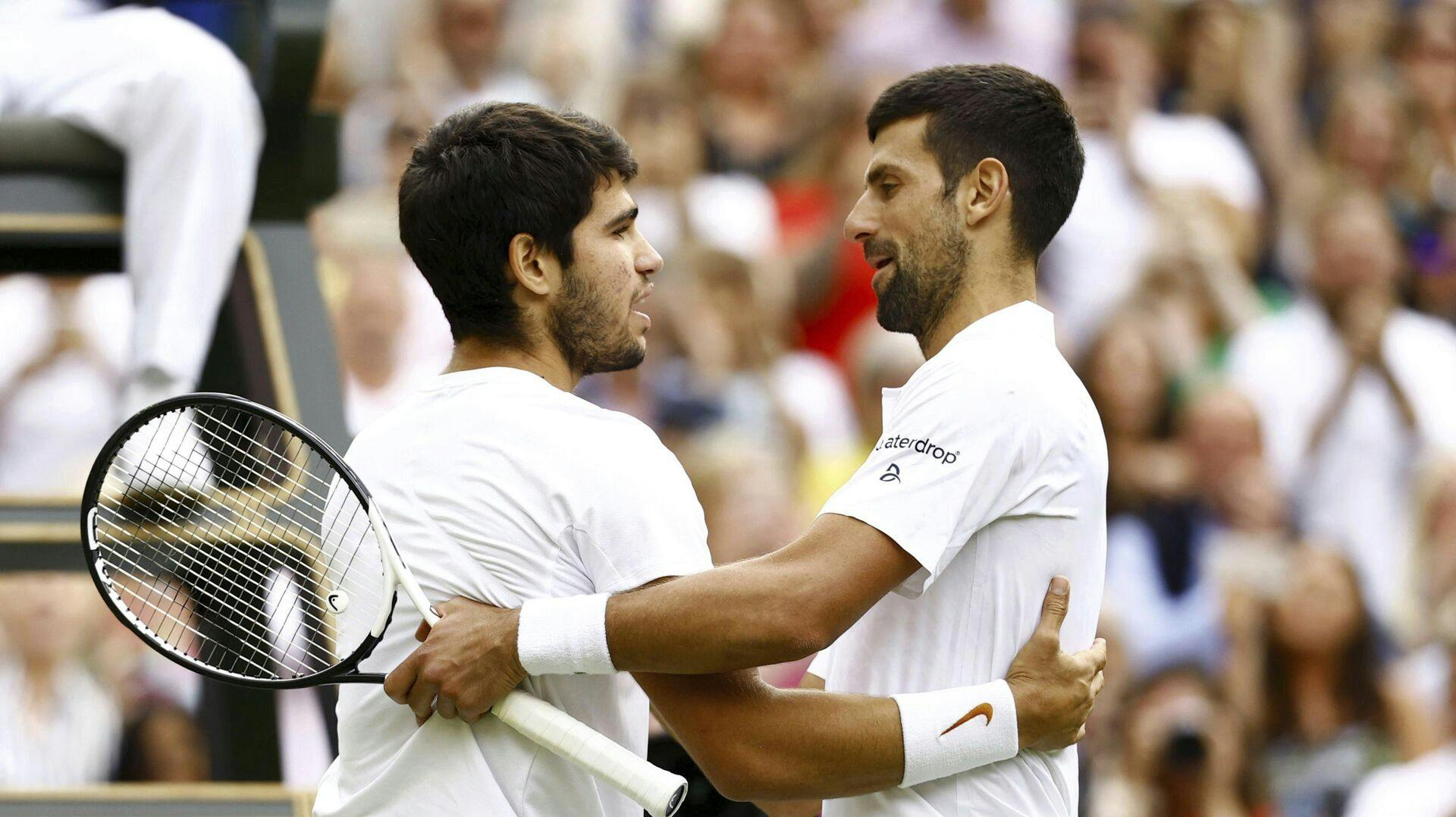 Spain's Carlos Alcaraz (L) hugs Serbia's Novak Djokovic after beating him in the men's singles final at the Wimbledon tennis tournament in London on July 16, 2023. (Kyodo via AP Images) ==Kyodo