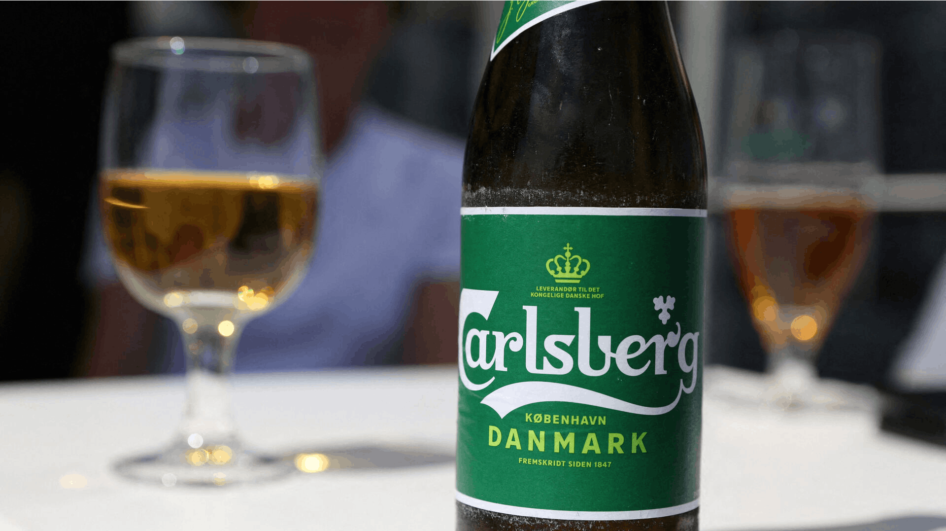 FILE PHOTO: A Carlsberg beer sits on a table in a restaurant in Copenhagen, Denmark, July 30, 2022. REUTERS/Andrew Kelly/File Photo