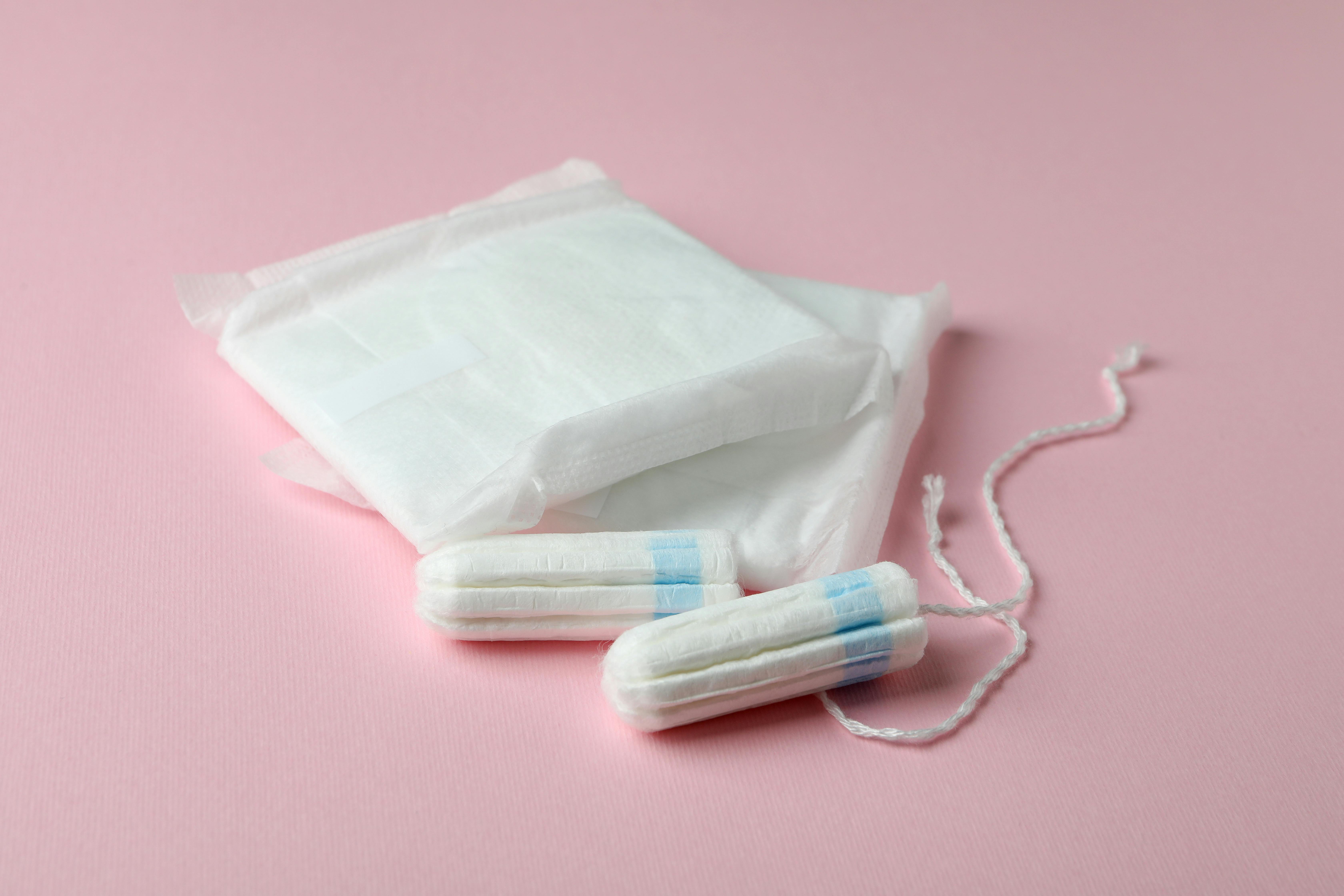 Sanitary pads and tampons on pink background