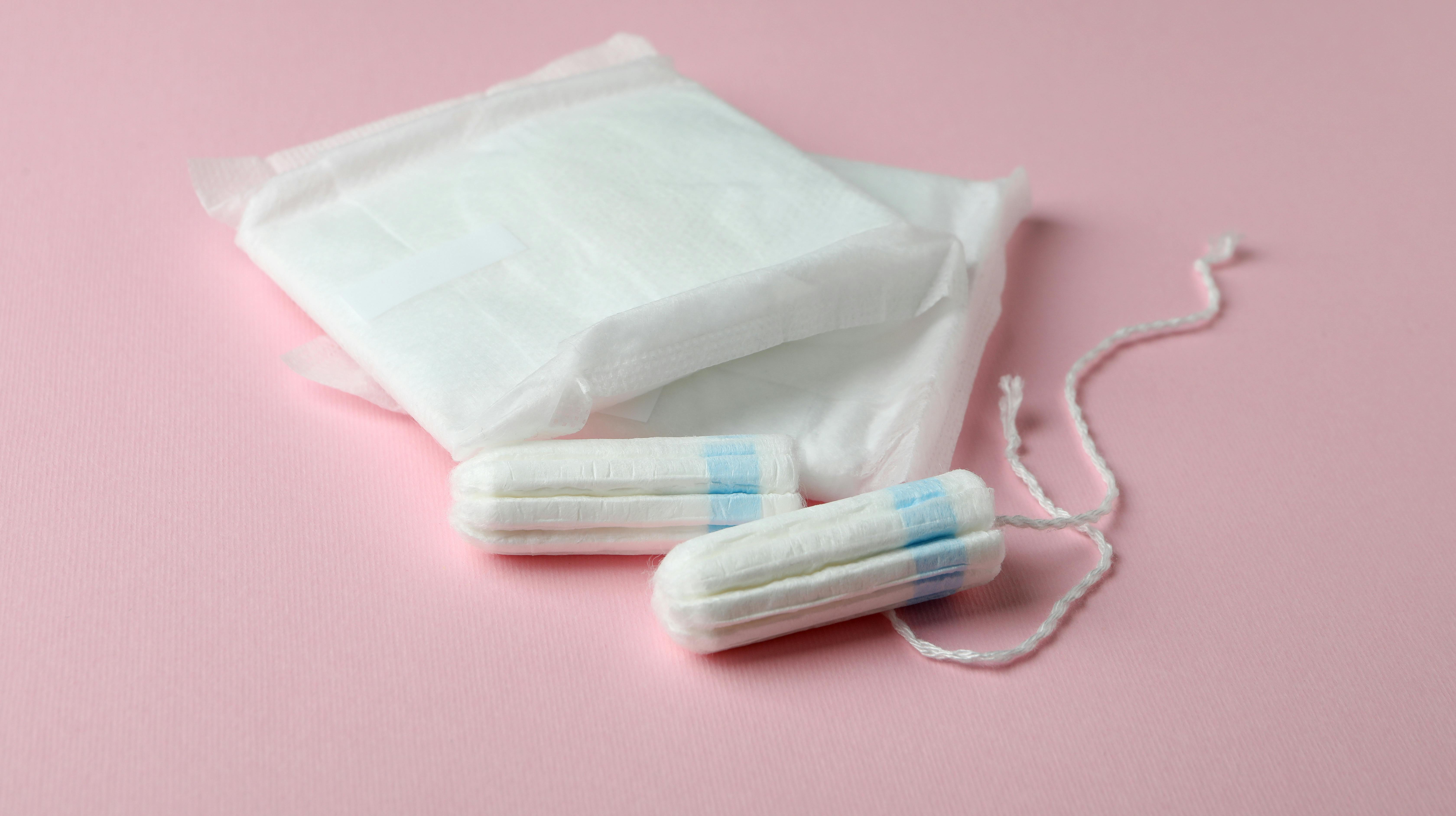 Sanitary pads and tampons on pink background