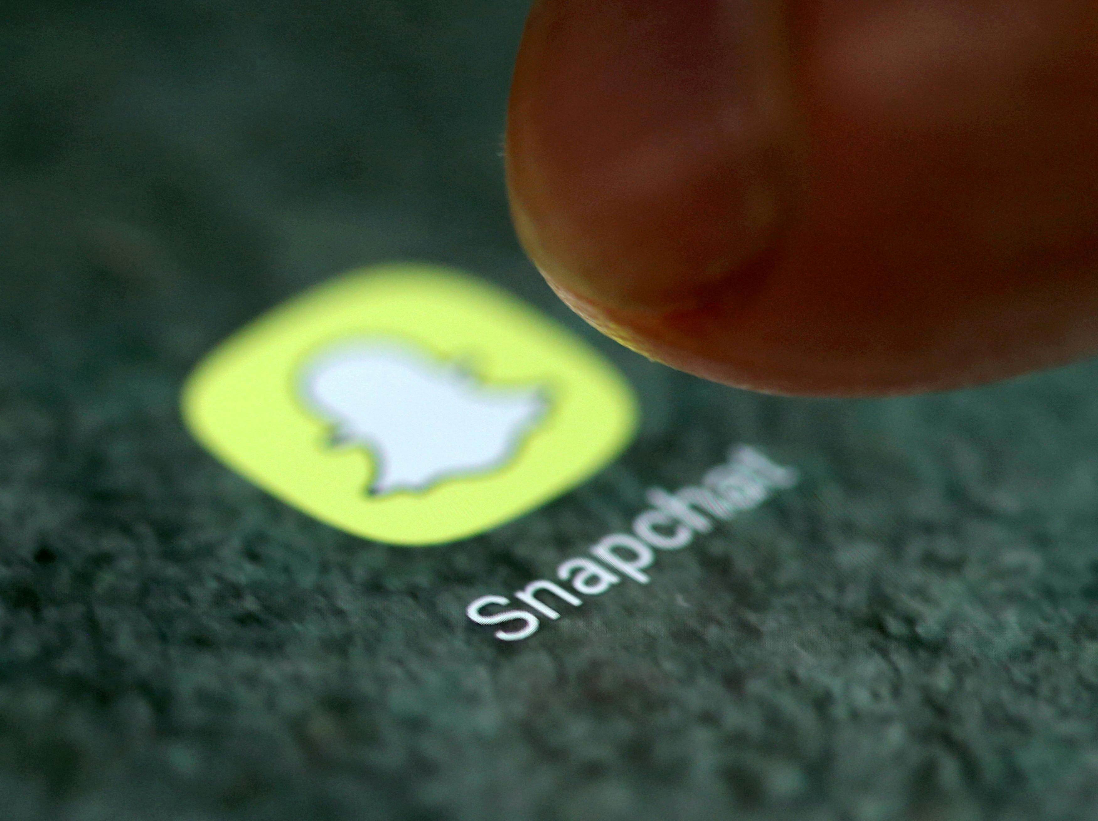 FILE PHOTO: The Snapchat app logo is seen on a smartphone in this picture illustration taken September 15, 2017. REUTERS/Dado Ruvic/Illustration/File Photo/File Photo/File Photo