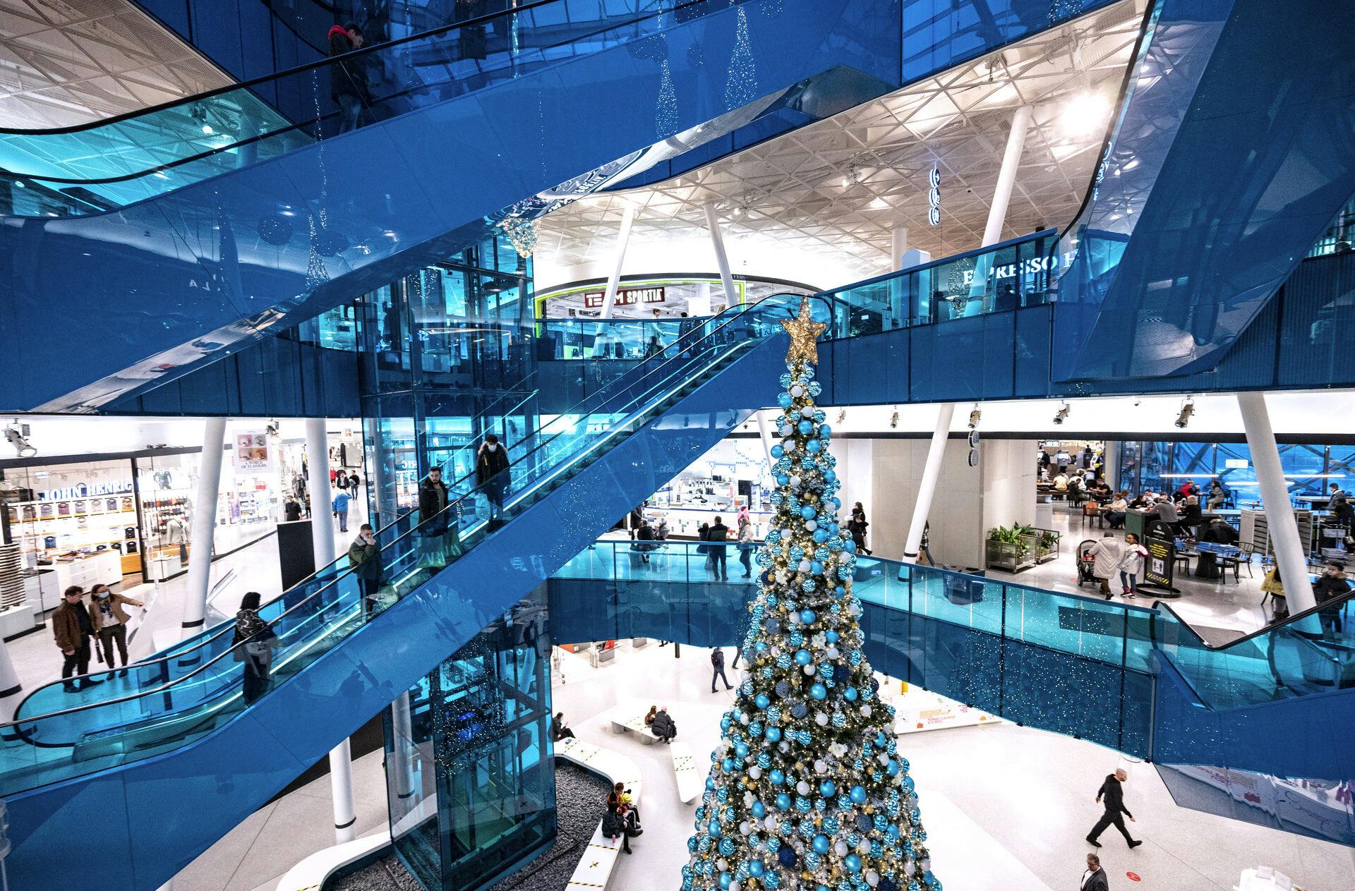 Christmas shoppers maintain social distancing as they ride on escalators in Emporia shopping centre in Malmo, Sweden, on December 20, 2020, amid the novel coronavirus / COVID-19 pandemic. Johan NILSSON / TT News Agency / AFP