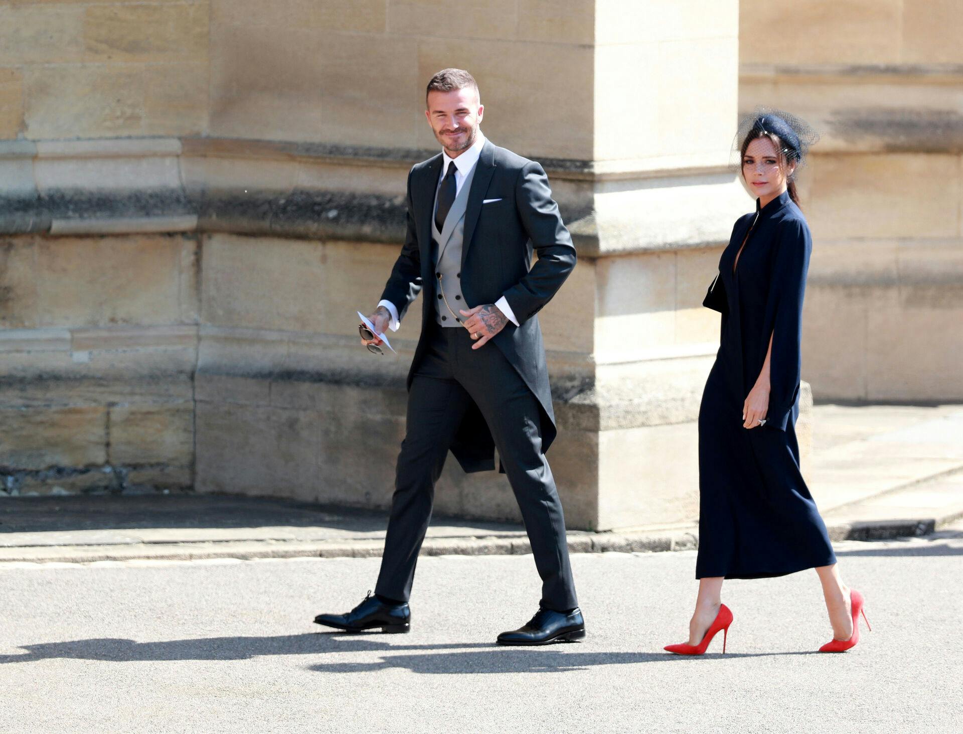 British fashion designer Victoria Beckham (R) and her husband, British former soccer player David Beckham arrive for the royal wedding ceremony of Britain's Prince Harry and Meghan Markle at St George's Chapel in Windsor Castle, in Windsor, Britain, 19 May 2018. LAUREN HURLEY/Pool via REUTERS
