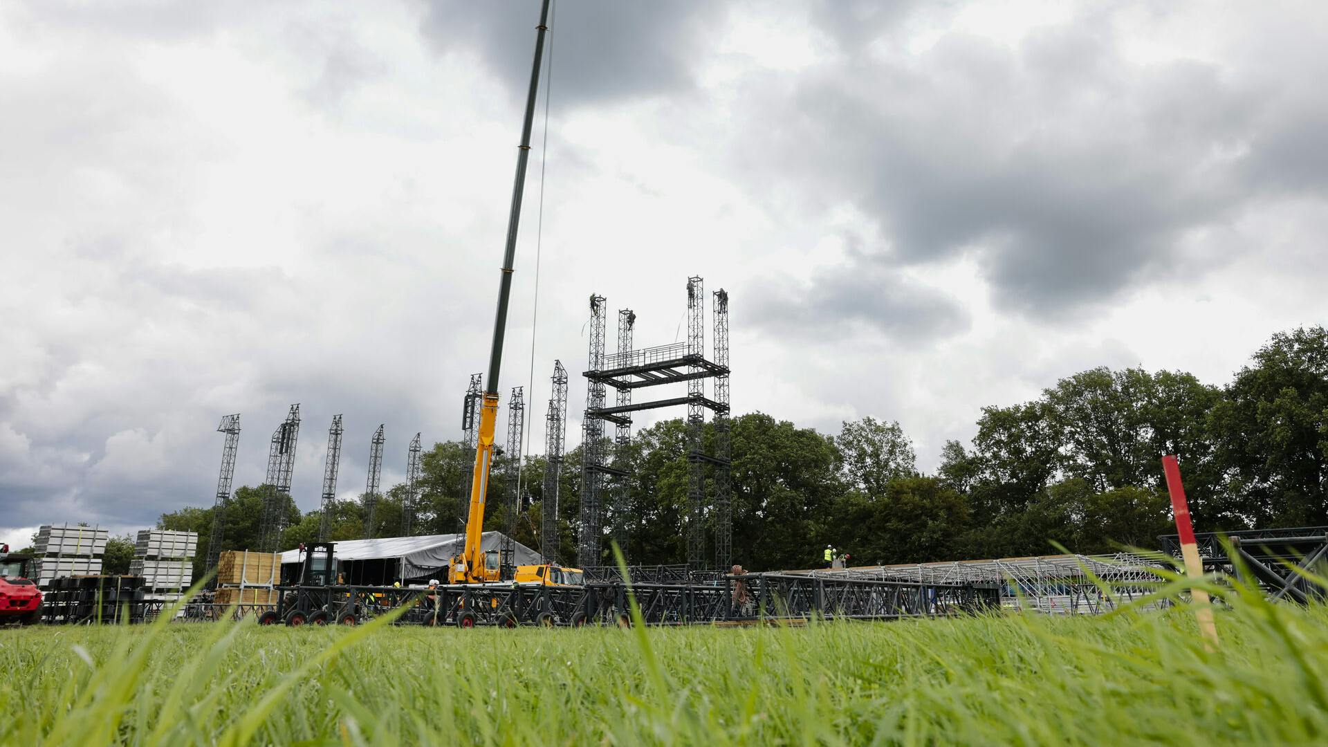 26 July 2023, Schleswig-Holstein, Wacken: Construction workers stand on scaffolding on the grounds of the Wacken Open Air (W:O:A). The heavy metal festival will take place from August 2 to 5, 2023. Already five hours after the start of the presale all 80000 tickets were sold out. Photo by: Frank Molter/picture-alliance/dpa/AP Images