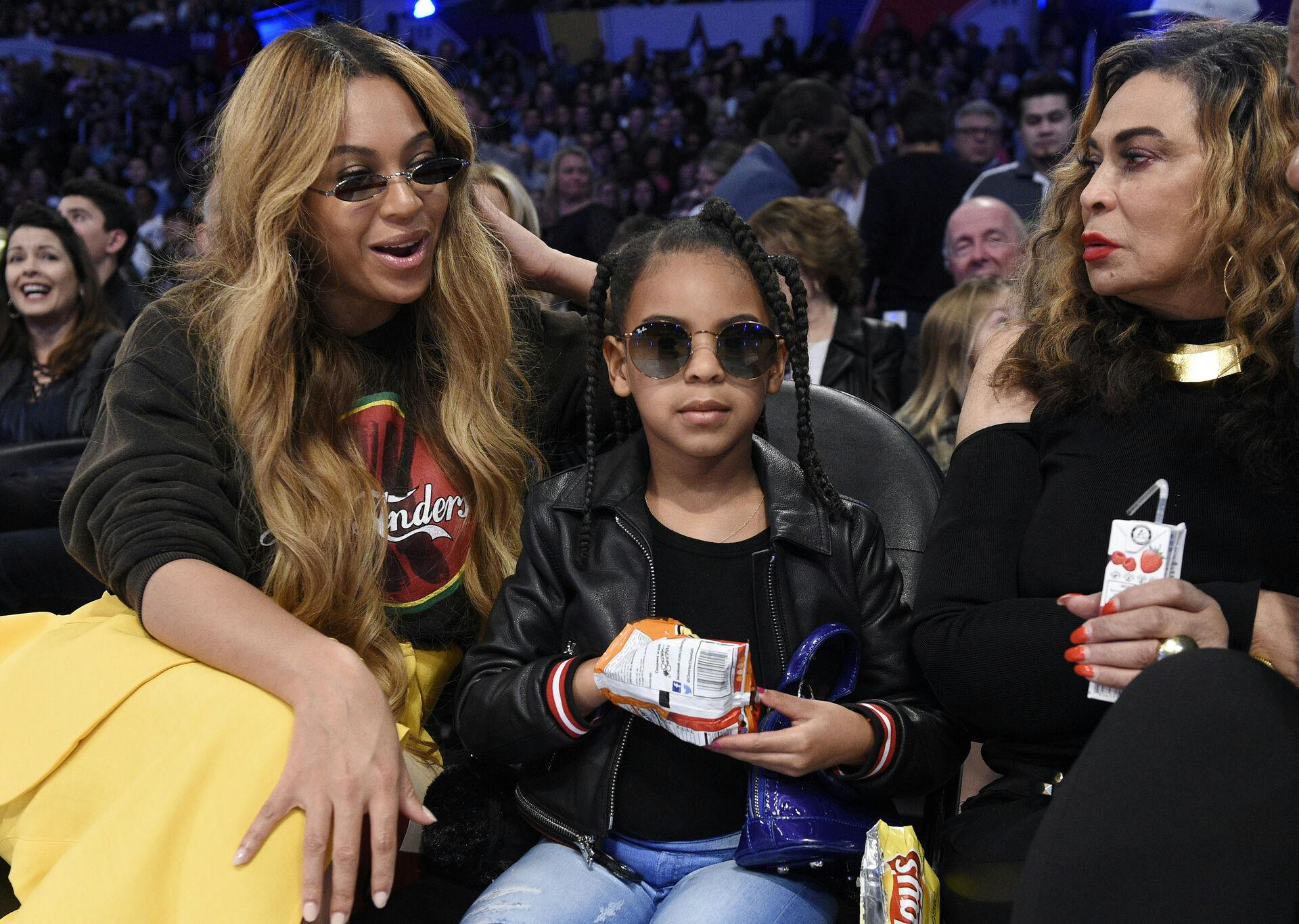 Singer Beyonce, left, sits with her daughter Blue Ivy Carter, center, and her mother Tina Knowles during the second half of an NBA All-Star basketball game, Sunday, Feb. 18, 2018, in Los Angeles. (AP Photo/Chris Pizzello)