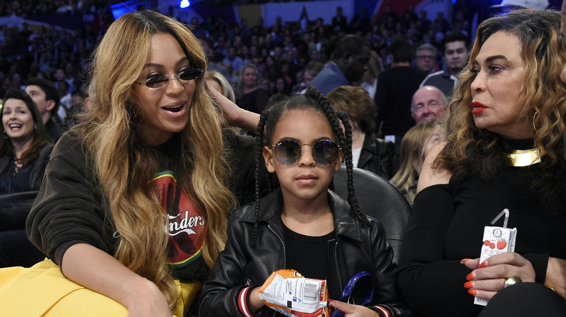 Singer Beyonce, left, sits with her daughter Blue Ivy Carter, center, and her mother Tina Knowles during the second half of an NBA All-Star basketball game, Sunday, Feb. 18, 2018, in Los Angeles. (AP Photo/Chris Pizzello)