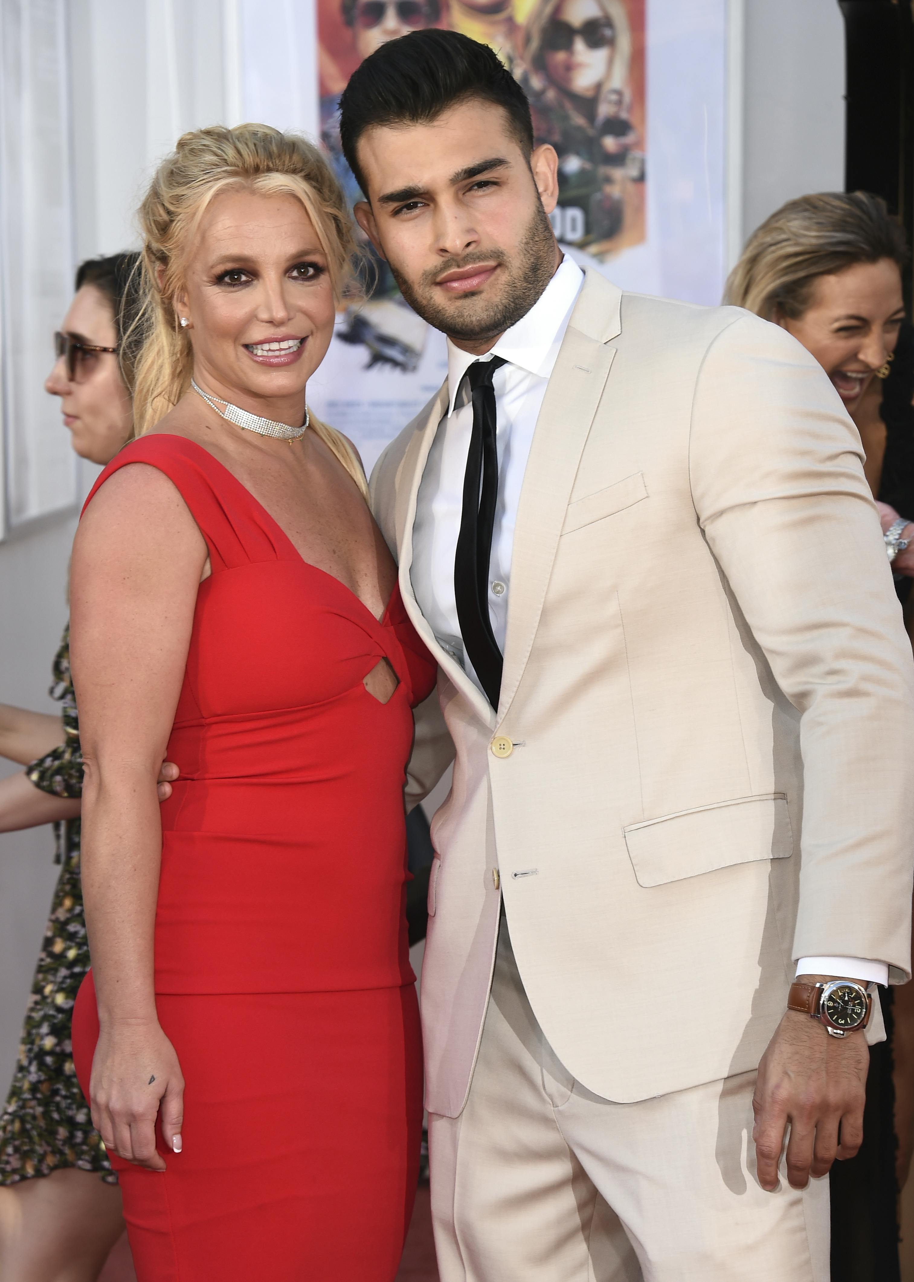 Britney Spears and Sam Asghari arrive at the Los Angeles premiere of "Once Upon a Time in Hollywood" at the TCL Chinese Theatre on July 22, 2019. Spears announced on Instagram on Sunday, Sept. 12, 2021, that she and Asghari are engaged. The couple met on the set of her 'Slumber Party' music video in 2016. (Photo by Jordan Strauss/Invision/AP, File)
