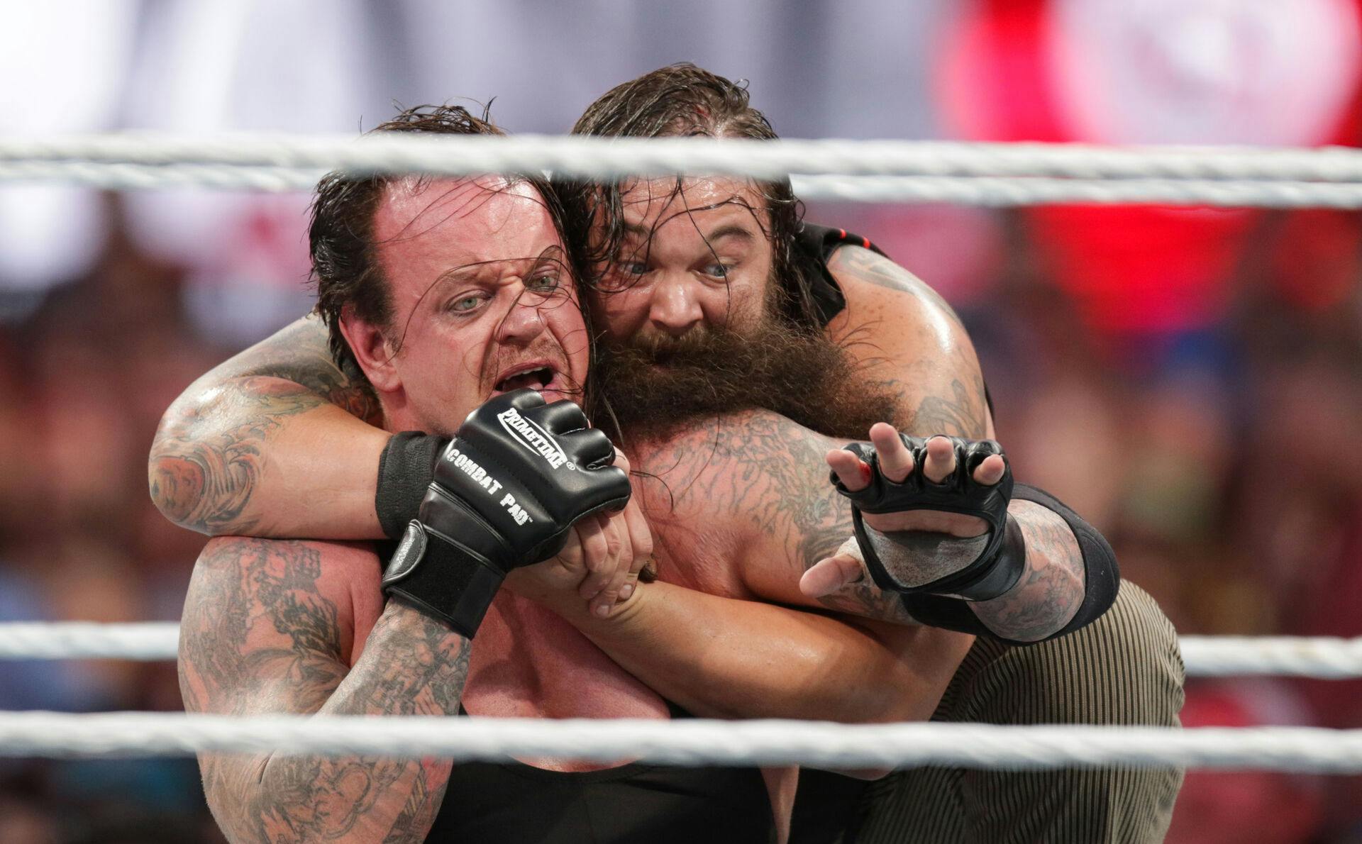 Bray Wyatt keeps his opponent The Undertaker in a hold at Wrestlemania XXXI