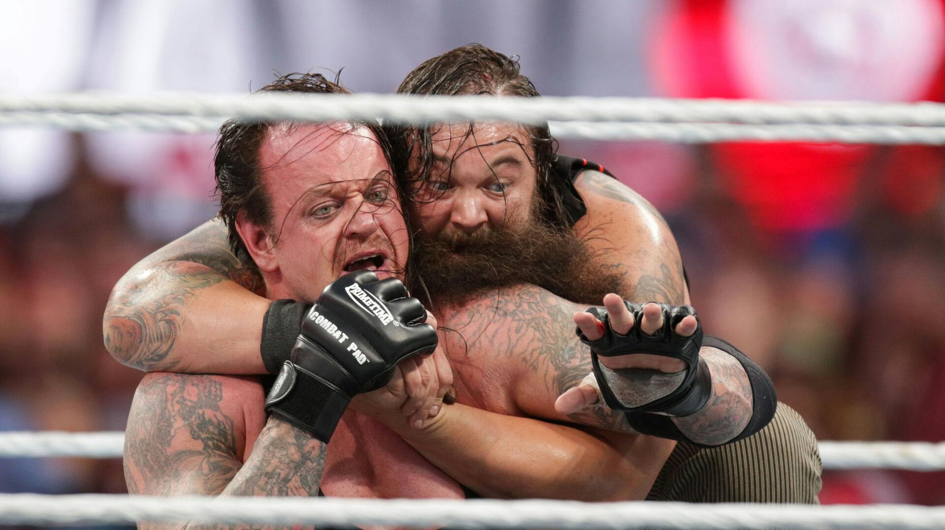 Bray Wyatt keeps his opponent The Undertaker in a hold at Wrestlemania XXXI