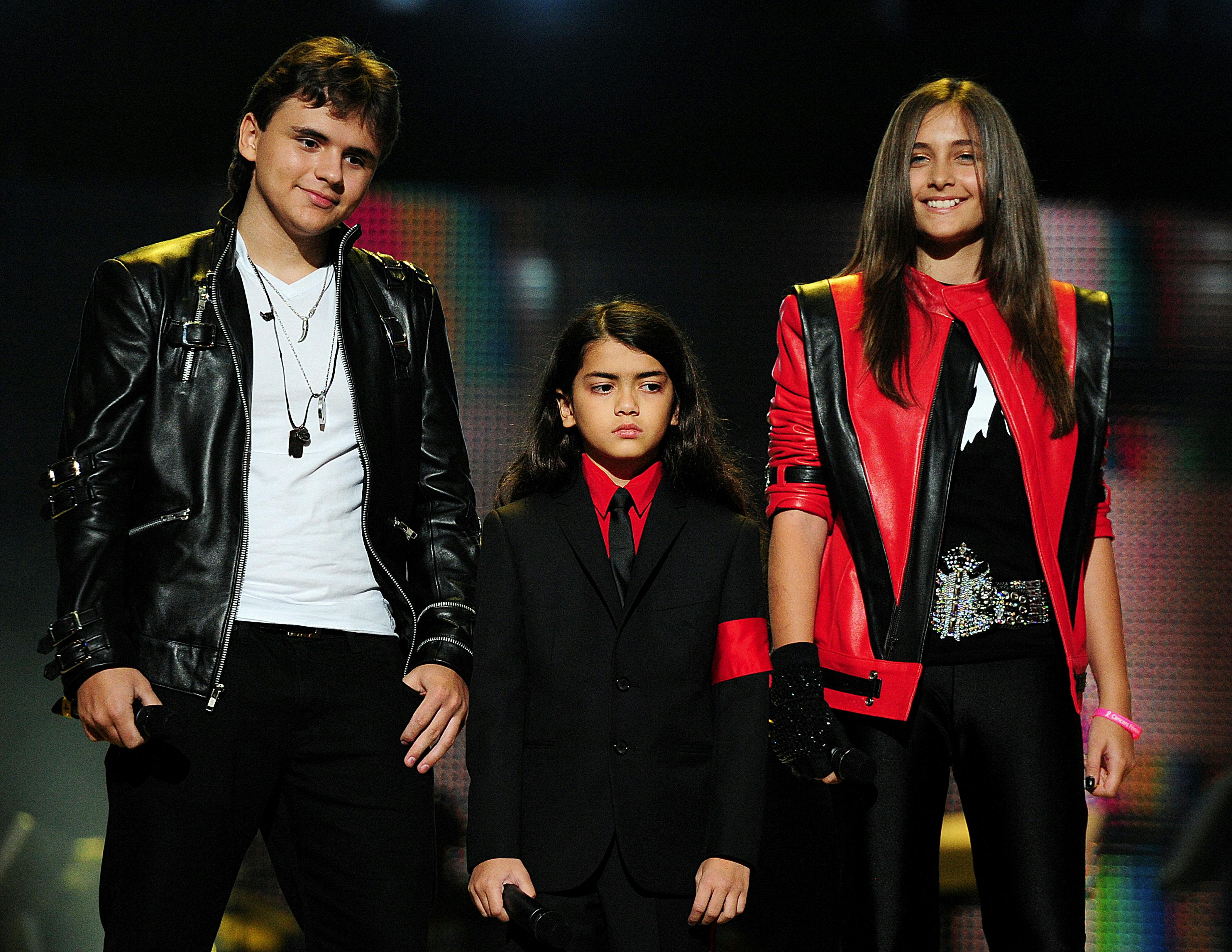 Michael Jackson's children, Prince Jackson (L), Blanket Jackson (C) and Paris Jackson (R) speak on stage during the 'Michael Forever' concert in memory of the late Michael Jackson at The Millenium Stadium in Cardiff, Wales on October 8, 2011. AFP PHOTO / LEON NEAL
