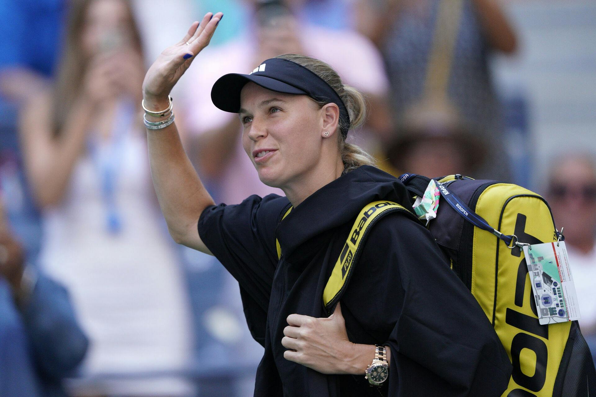 Caroline Wozniacki, of Denmark, waves while arriving on court to face Coco Gauff, of the United States, during the fourth round of the U.S. Open tennis championships, Sunday, Sept. 3, 2023, in New York. (AP Photo/Eduardo Munoz Alvarez)