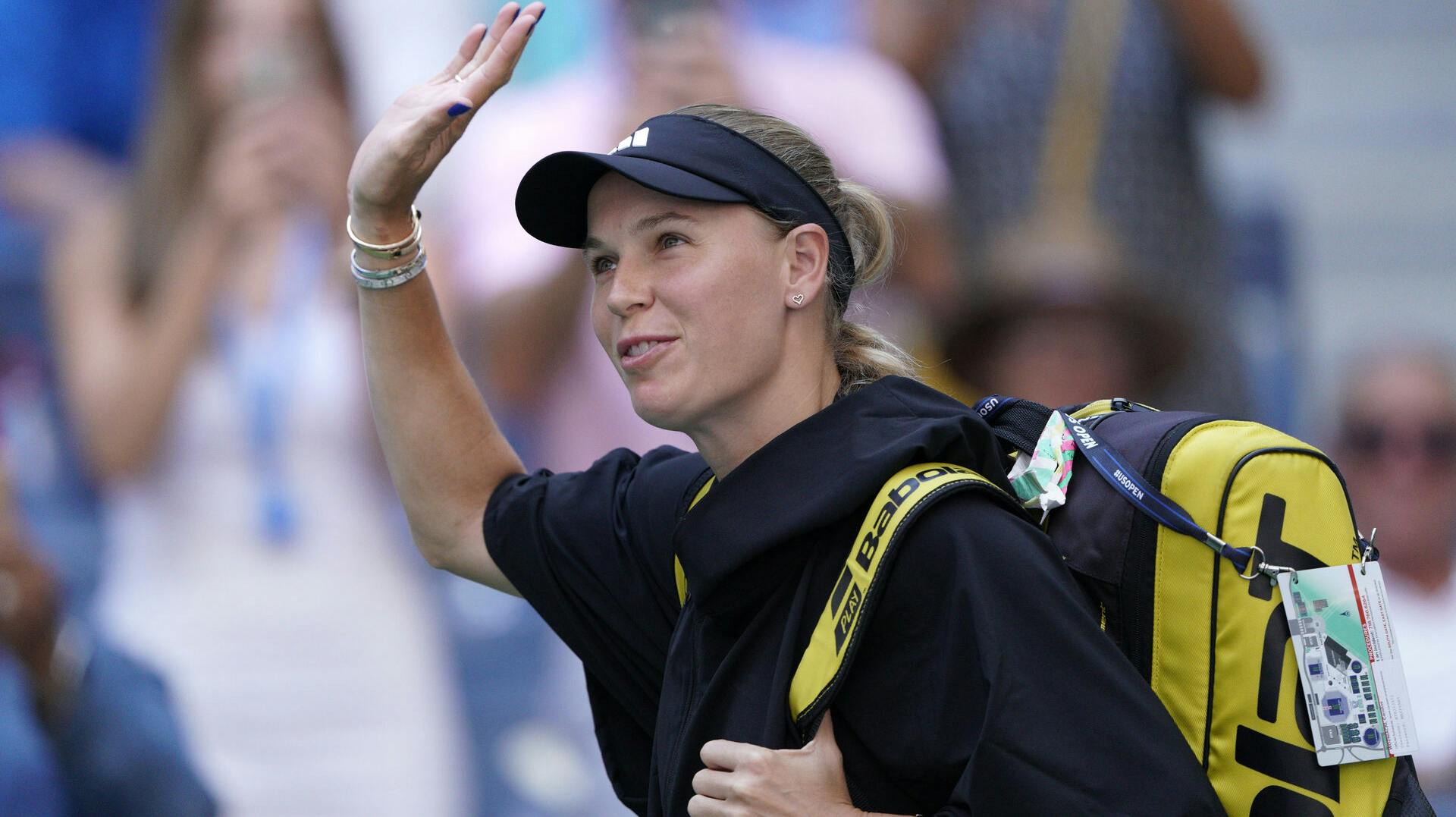 Caroline Wozniacki, of Denmark, waves while arriving on court to face Coco Gauff, of the United States, during the fourth round of the U.S. Open tennis championships, Sunday, Sept. 3, 2023, in New York. (AP Photo/Eduardo Munoz Alvarez)