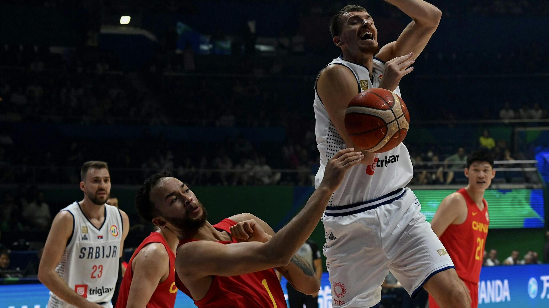 China's Kaier Li (L) blocks the ball from Serbia's Borisa Simanic (R) during the FIBA Basketball World Cup group B match between China and Serbia at Smart Araneta Coliseum in Quezon City on August 26, 2023. (Photo by JAM STA ROSA / AFP)