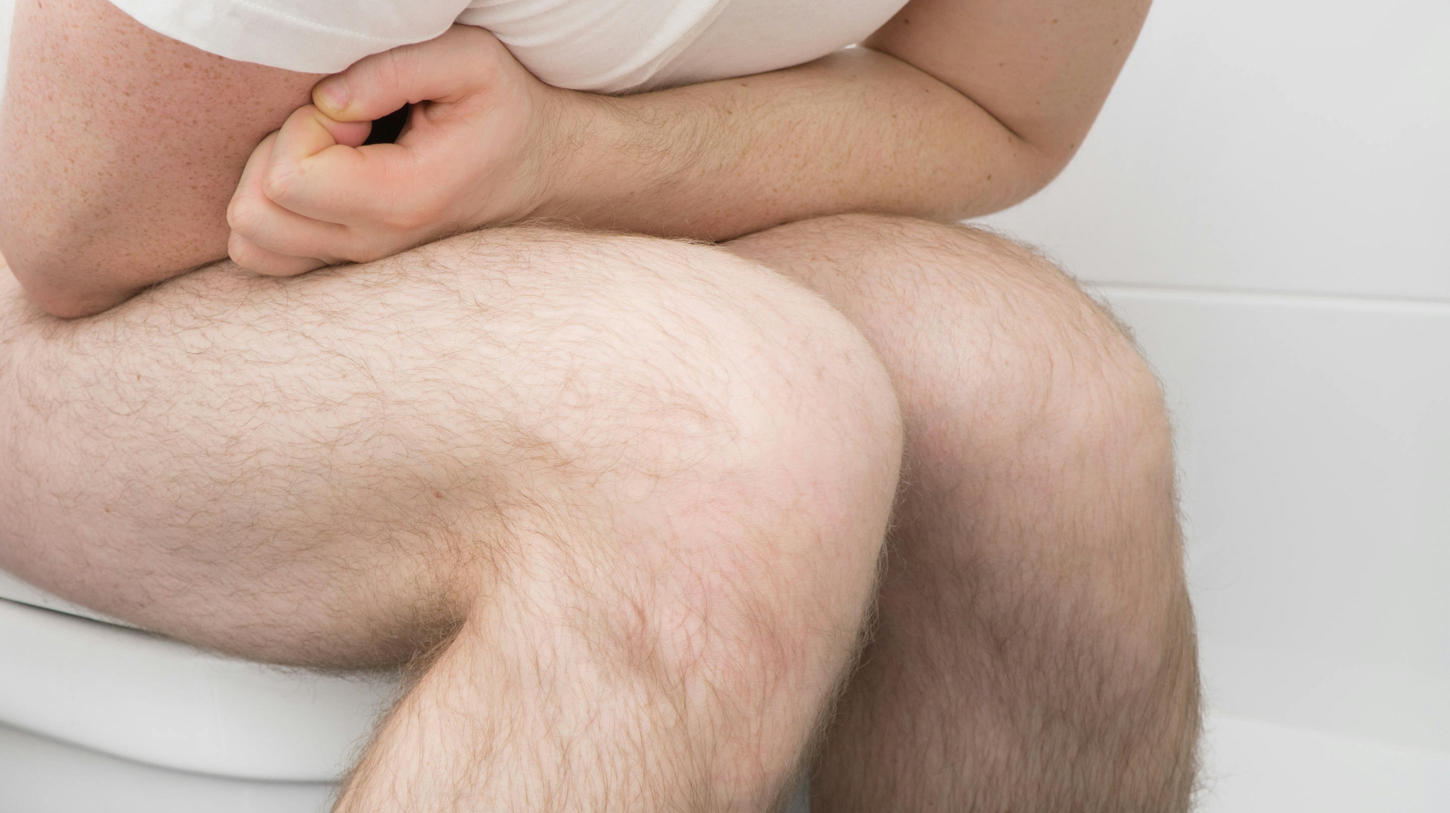 Man sitting on wc and suffering from diarrhea.