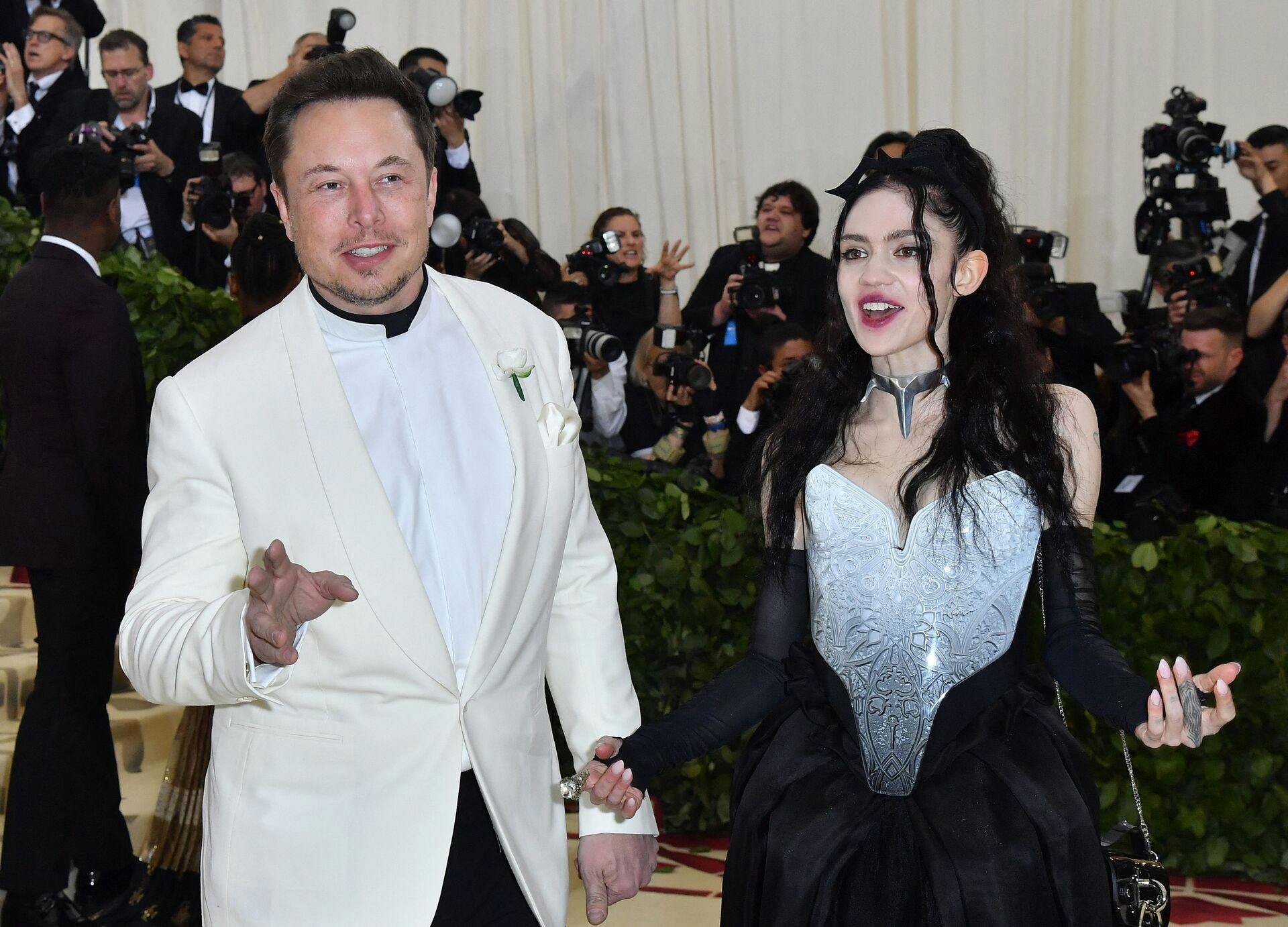 (FILES) In this file photo taken on May 07, 2018, Elon Musk and Grimes arrive for the 2018 Met Gala at the Metropolitan Museum of Art in New York. - Billionaire entrepreneur Elon Musk and the musician Grimes have had a second child, a girl they named Exa Dark Sideræl Musk - - although the parents will mostly call her Y. The 33-year-old Grimes revealed the existence of the child, who was born in December, in an interview published on March 10, 2022, by Vanity Fair. (Photo by ANGELA WEISS / AFP)