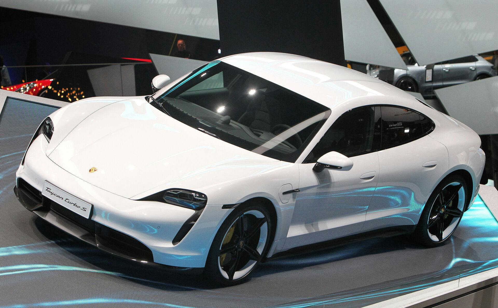 A Porsche Taycan Turbo S car is pictured at the company's booth at the International Auto Show (IAA), in Frankfurt am Main, on September 11, 2019. Frankfurt's biennial International Auto Show (IAA) opens its doors to the public on September 12, 2019, but major foreign carmakers are staying away while climate demonstrators march outside - - forming a microcosm of the under-pressure industry's woes. Daniel ROLAND / AFP