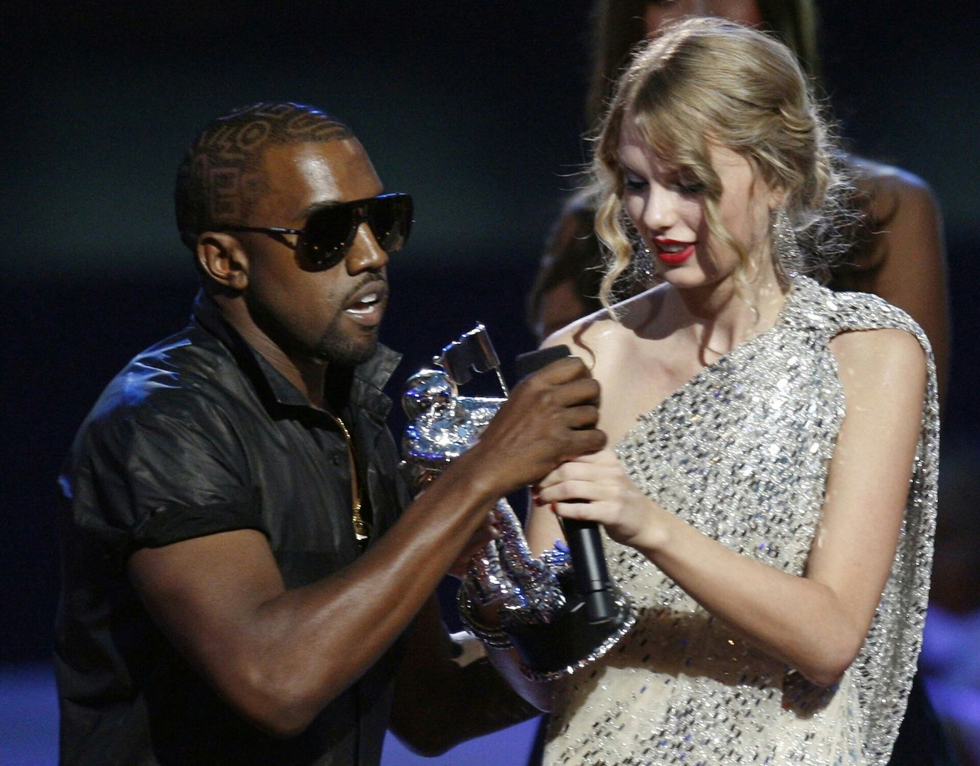 Kanye West takes the microphone from best female video winner Taylor Swift as he praises the video entry from Beyonce at the 2009 MTV Video Music Awards in New York, September 13, 2009. REUTERS/Gary Hershorn (UNITED STATES ENTERTAINMENT)