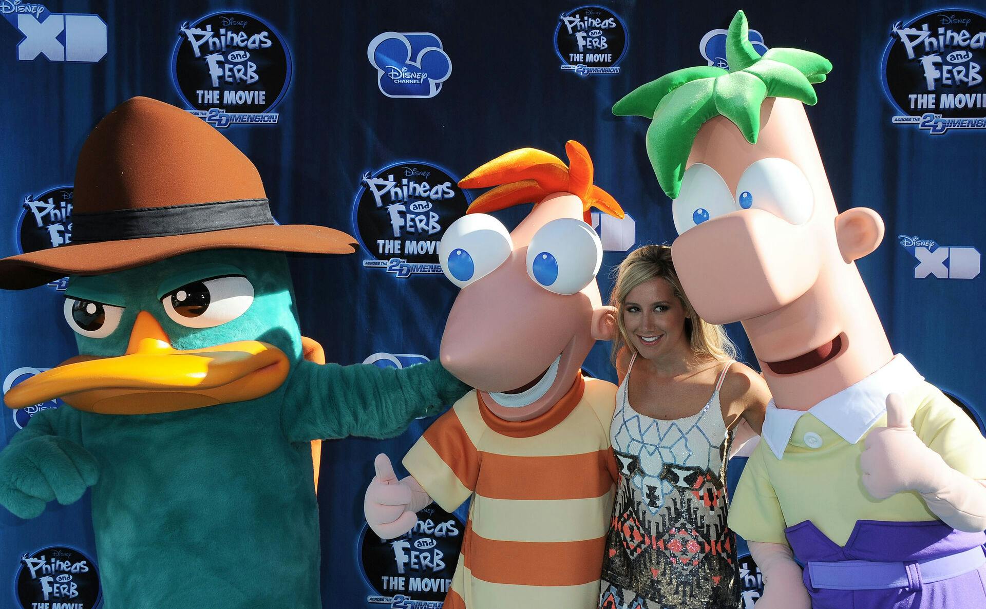 Ashley Tisdale poses with characters from the film at the premiere of "Phineas and Ferb: Across The Second Dimension" at El Capitan Theater in Los Angeles, Wednesday, August 3, 2011. The film will be aired on The Disney Channel August 5, 2011. (AP Photo/Katy Winn)