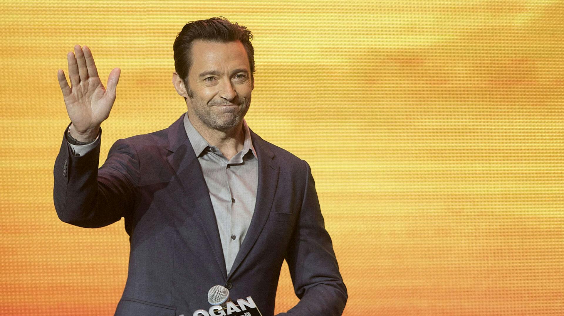 Actor Hugh Jackman waves as he arrives for a press conference for the movie "Logan" in Beijing, Wednesday, March 1, 2017. The superhero film opens in China on March 3. (AP Photo/Mark Schiefelbein)