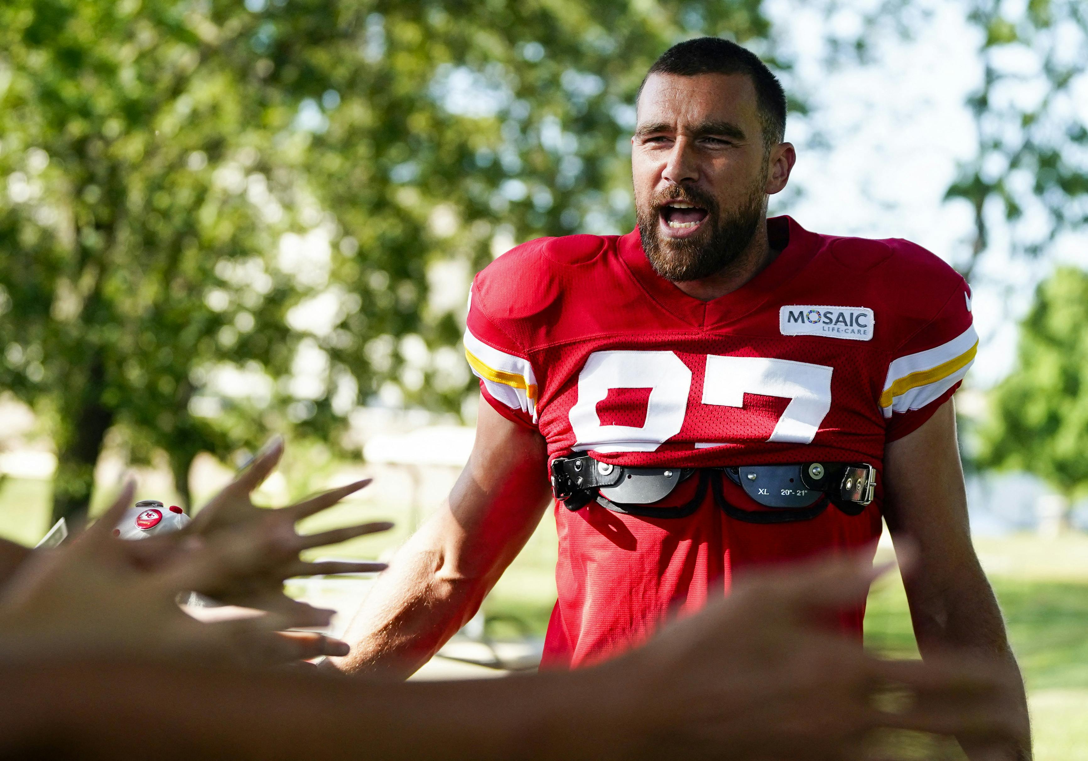 Jul 28, 2023; St. Joseph, MO, USA; Kansas City Chiefs tight end Travis Kelce (87) greets fans as he arrives prior to training camp at Missouri Western State University. Mandatory Credit: Jay Biggerstaff-USA TODAY Sports