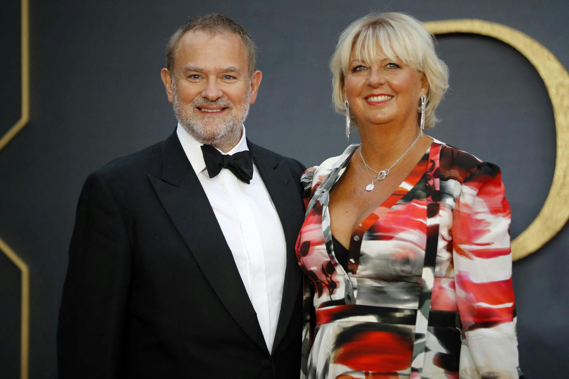 British actor Hugh Bonneville (L) and his wife Lulu Williams (R) pose on the red carpet upon arrival for the world premiere of the film "Downton Abbey" in London on September 9, 2019. Tolga AKMEN / AFP