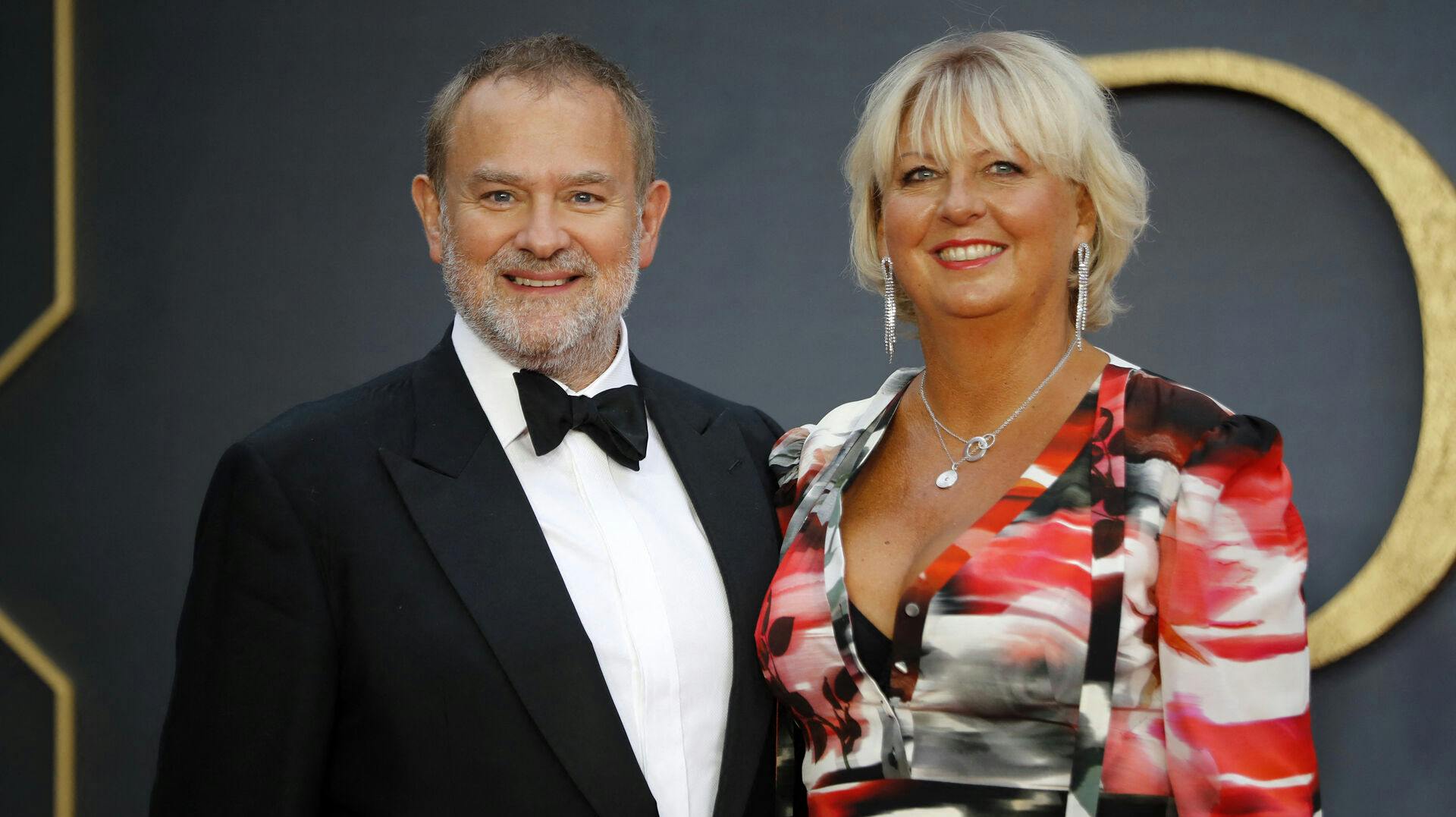 British actor Hugh Bonneville (L) and his wife Lulu Williams (R) pose on the red carpet upon arrival for the world premiere of the film "Downton Abbey" in London on September 9, 2019. Tolga AKMEN / AFP