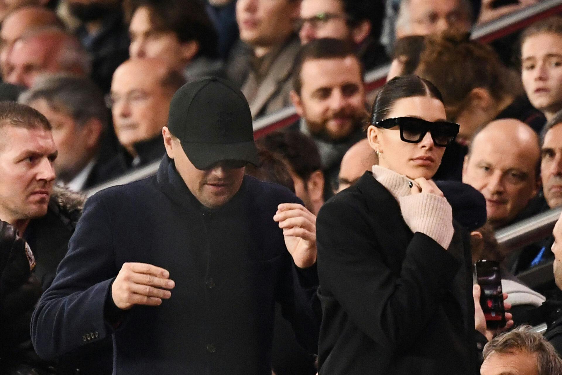 US actor Leonardo Di Caprio (C) and his partner Argentinian and US model Camilla Morrone (R) attend the UEFA Champions League Group C football match between Paris Saint-Germain (PSG) and Liverpool FC at the Parc des Princes stadium, in Paris, on November 28, 2018.  FRANCK FIFE / AFP