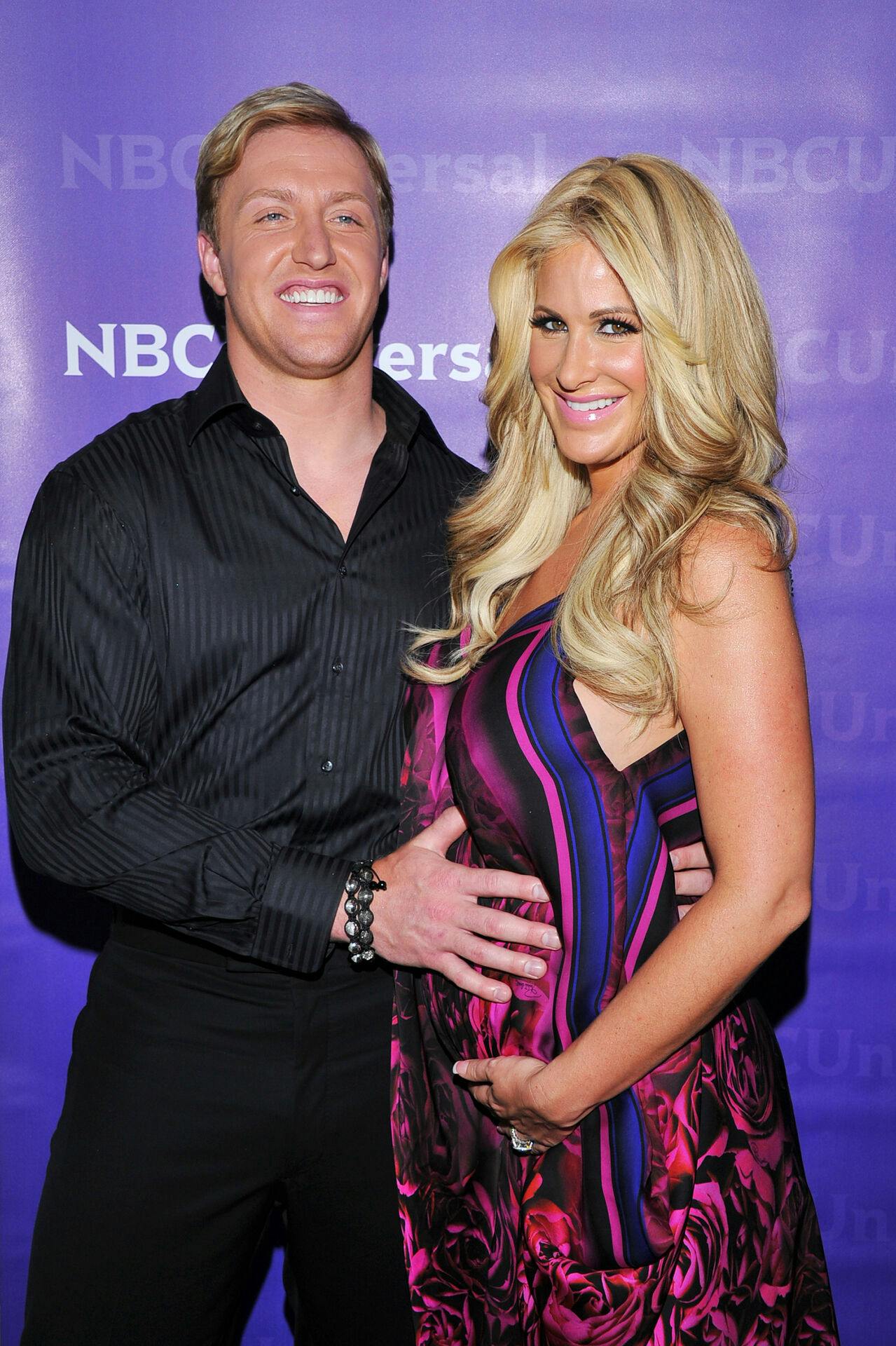 Atlanta Falcons football player Kroy Biermann, left, and his wife Kim Zolciak from "The Real Housewives of Atlanta, " arrive at the 2012 NBC Universal Press Day on Wednesday, April 18, 2012 in Pasadena, Calif. (AP Photo/Vince Bucci)