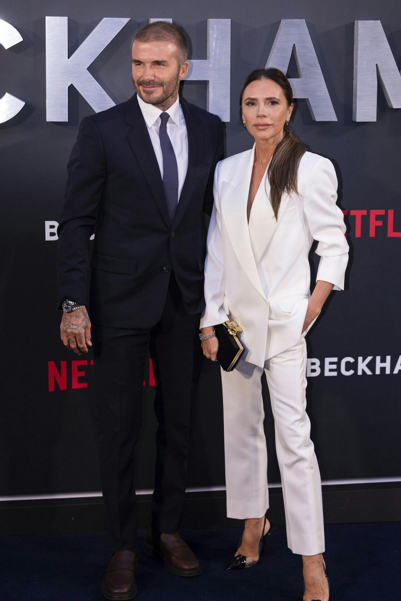 David Beckham, left, and Victoria Beckham pose for photographers upon arrival at the premiere of the television programme 'Beckham' on Tuesday, Oct. 3, 2023 in London. (AP Photo/Vianney Le Caer)