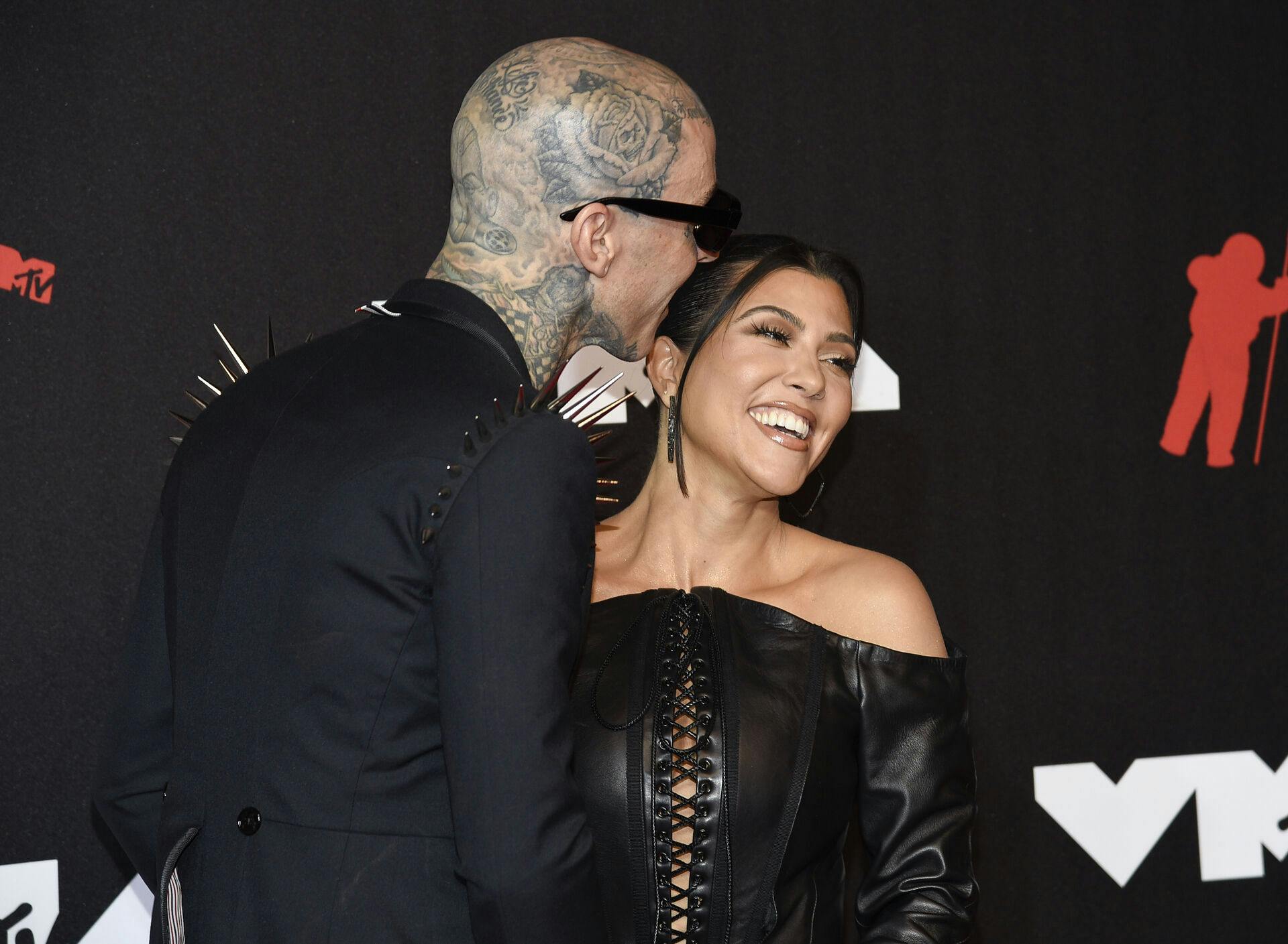 Travis Barker, left, and Kourtney Kardashian arrive at the MTV Video Music Awards at Barclays Center on Sunday, Sept. 12, 2021, in New York. (Photo by Evan Agostini/Invision/AP)