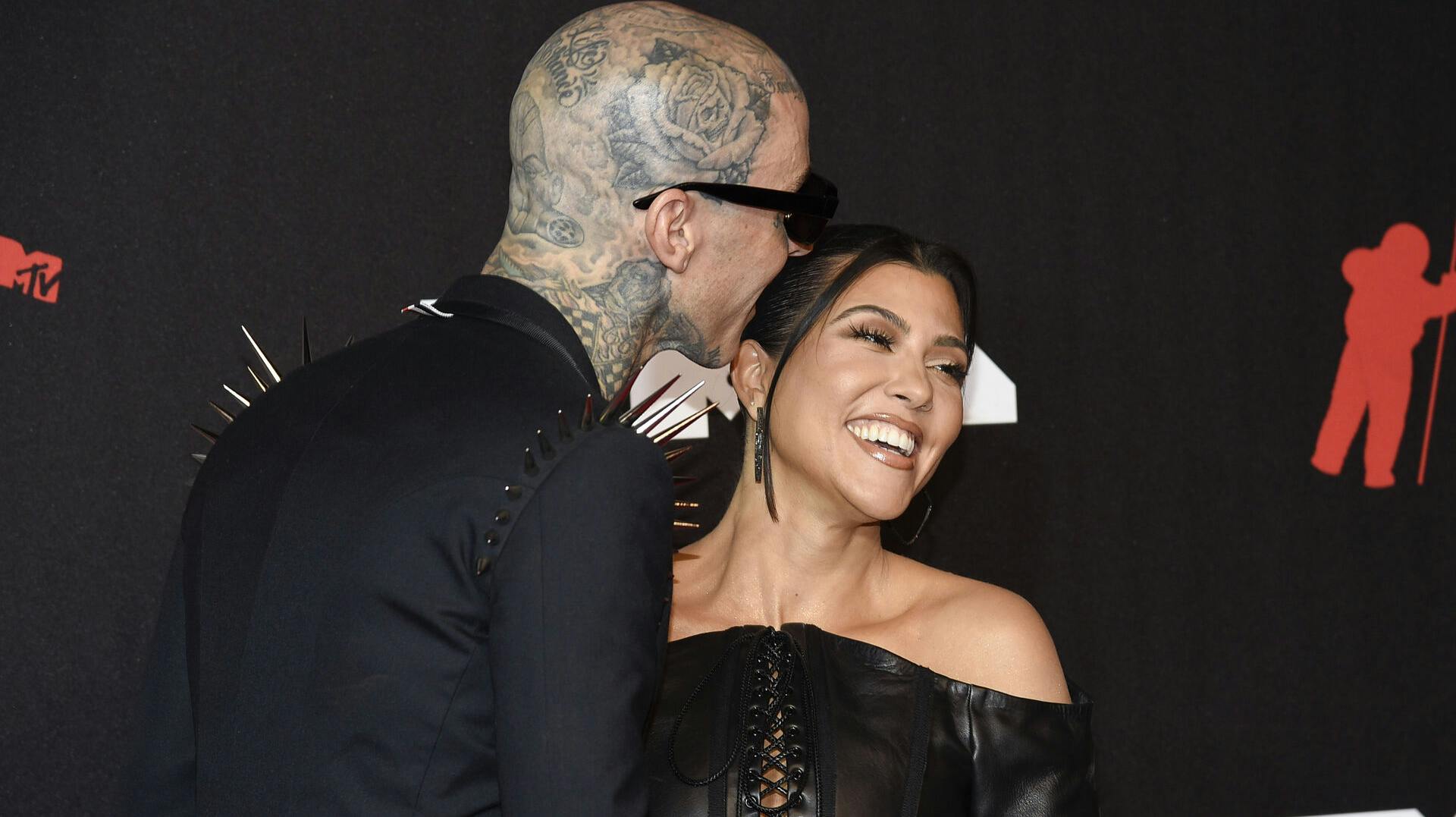 Travis Barker, left, and Kourtney Kardashian arrive at the MTV Video Music Awards at Barclays Center on Sunday, Sept. 12, 2021, in New York. (Photo by Evan Agostini/Invision/AP)