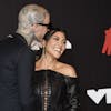 Travis Barker, left, and Kourtney Kardashian arrive at the MTV Video Music Awards at Barclays Center on Sunday, Sept. 12, 2021, in New York. (Photo by Evan Agostini/Invision/AP)