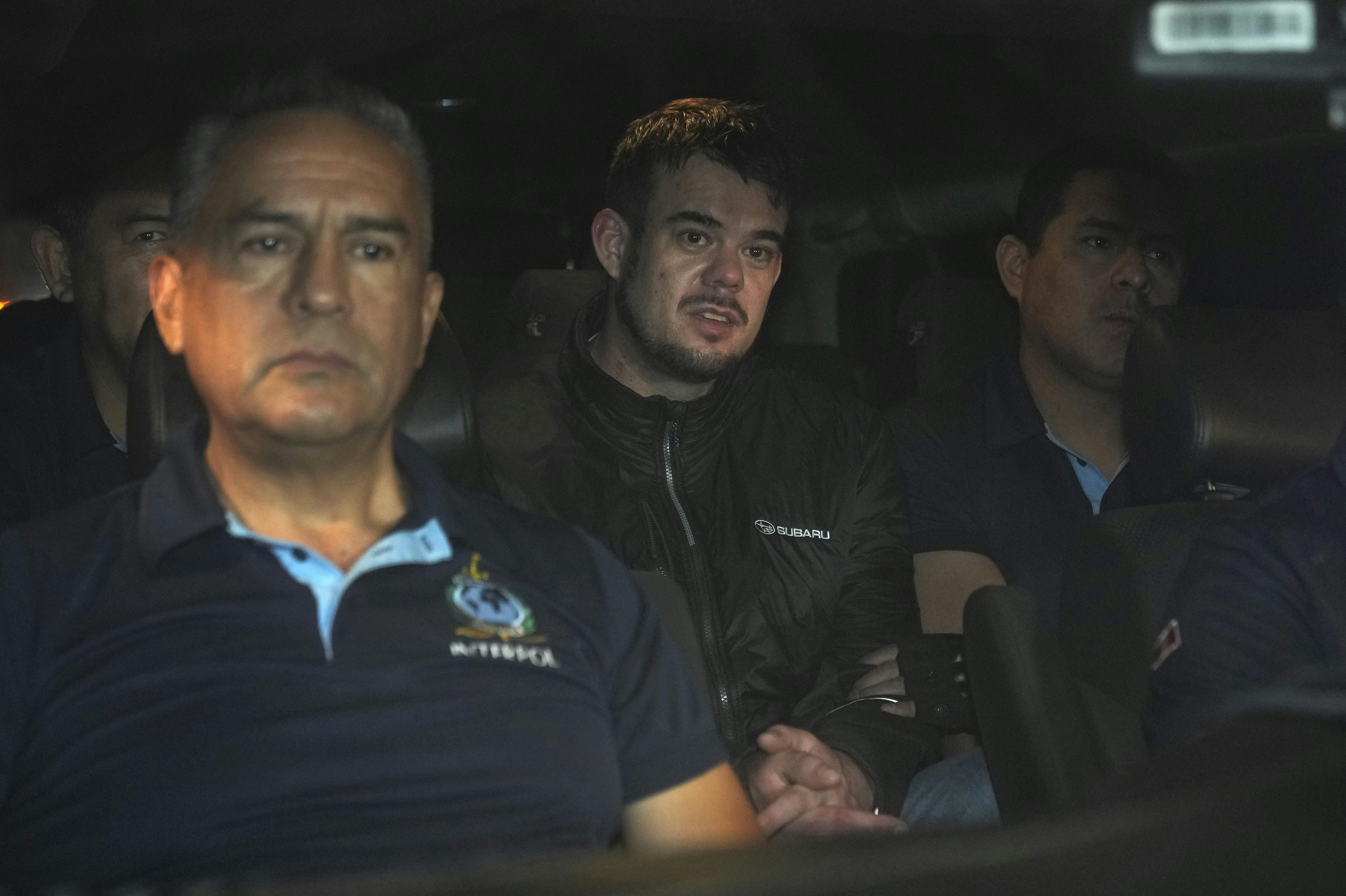 Dutch citizen Joran van der Sloot, center, is driven in a police vehicle from the Ancon I maximum-security prison, outskirts of Lima, Peru, early Thursday, June 8, 2023. The main suspect in the unsolved 2005 disappearance of American student Natalee Holloway on the Caribbean island of Aruba is expected to be extradited Thursday from Peru to the United States. (AP Photo/Martin Mejia)