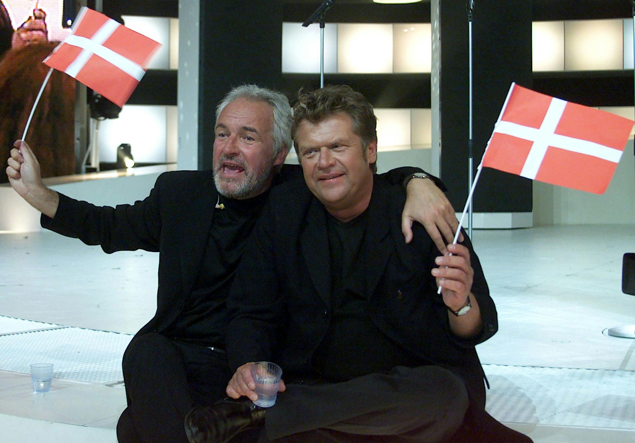 Jørgen Olsen (L) and his brother Niels from Denmark wave Danish flags after they won the Grand Prix Eurovision Song Contest 2000 in Stockholm May 13. The Olsen brothers won with their song "Fly on the wings of love".