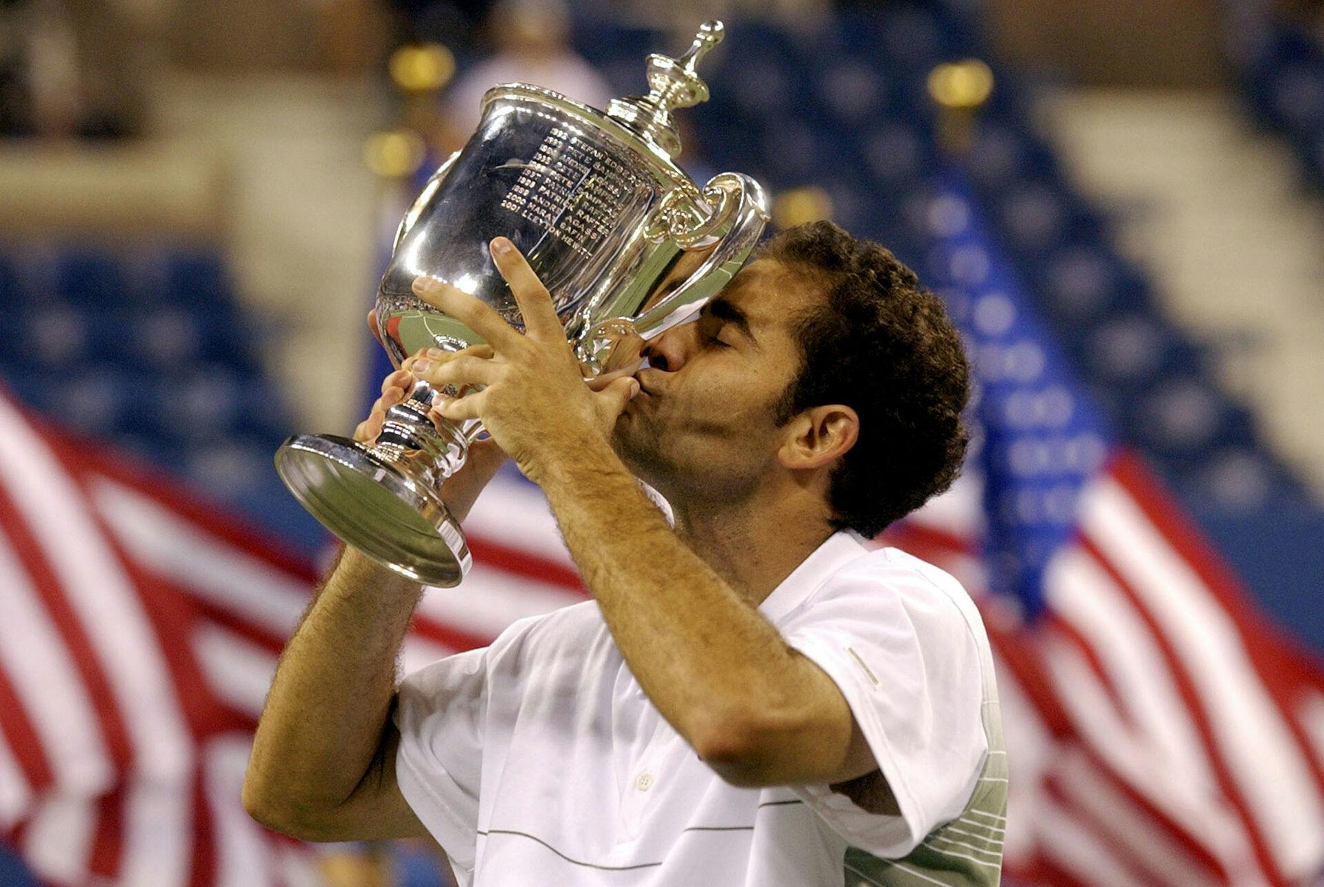 FILE - Pete Sampra kisses the trophy after his 6-3, 6-4, 5-7, 6-4 win over compatriot Andre Agassi in the men's final at the U.S. Open tennis tournament in New York, in this Sunday, Sept. 8, 2002, file photo. (AP Photo/Amy Sancetta, File)